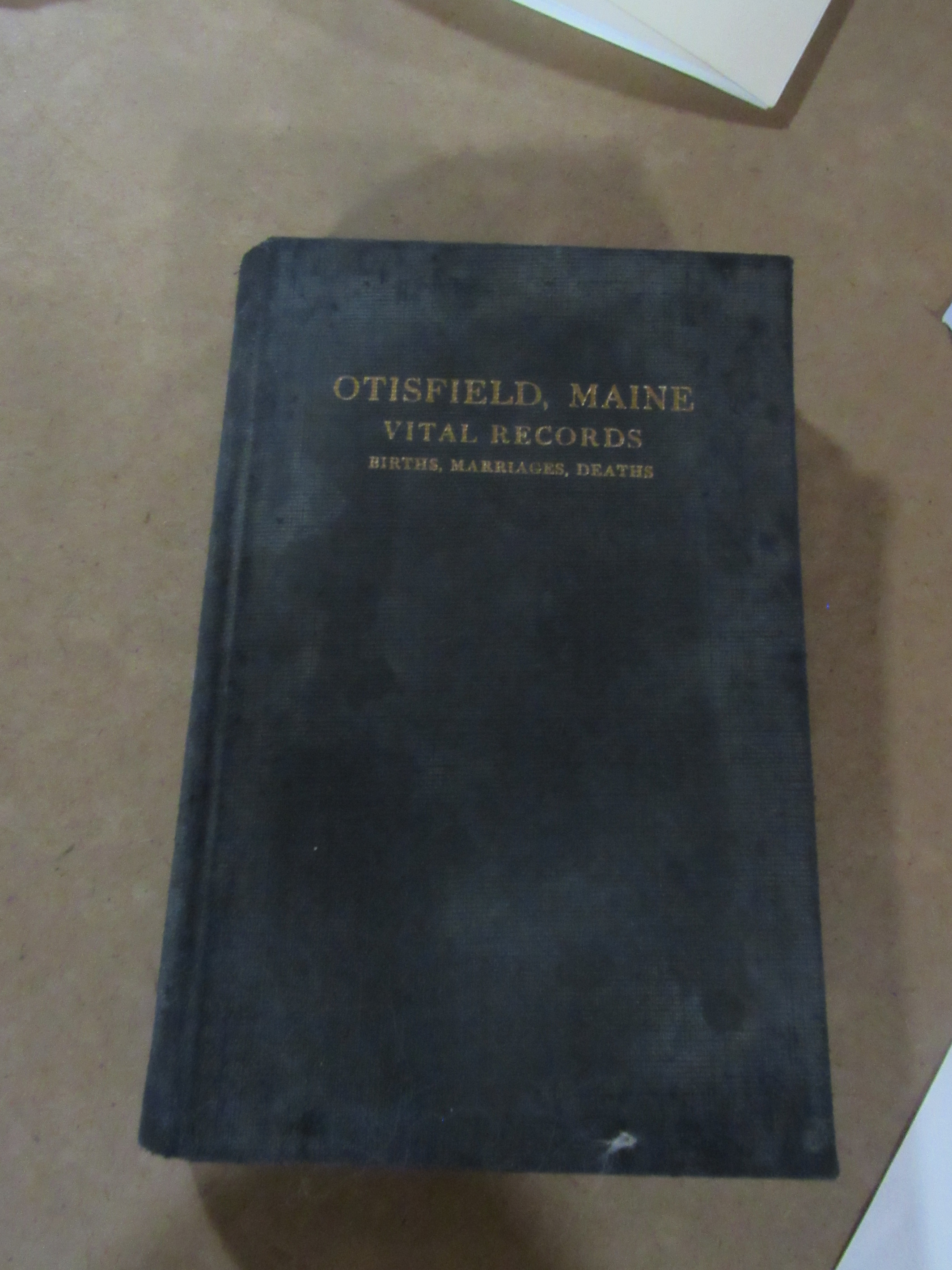 Photograph of Otisfield vital records book cover.