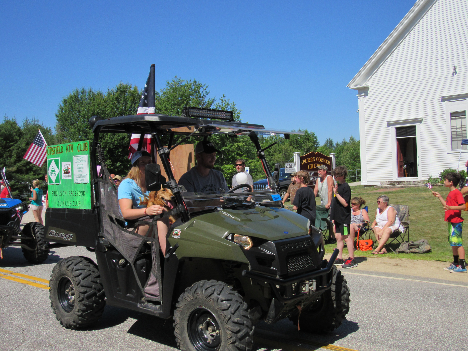 Side-by-side utility vehicle in the parade at the Fourth of July parade.