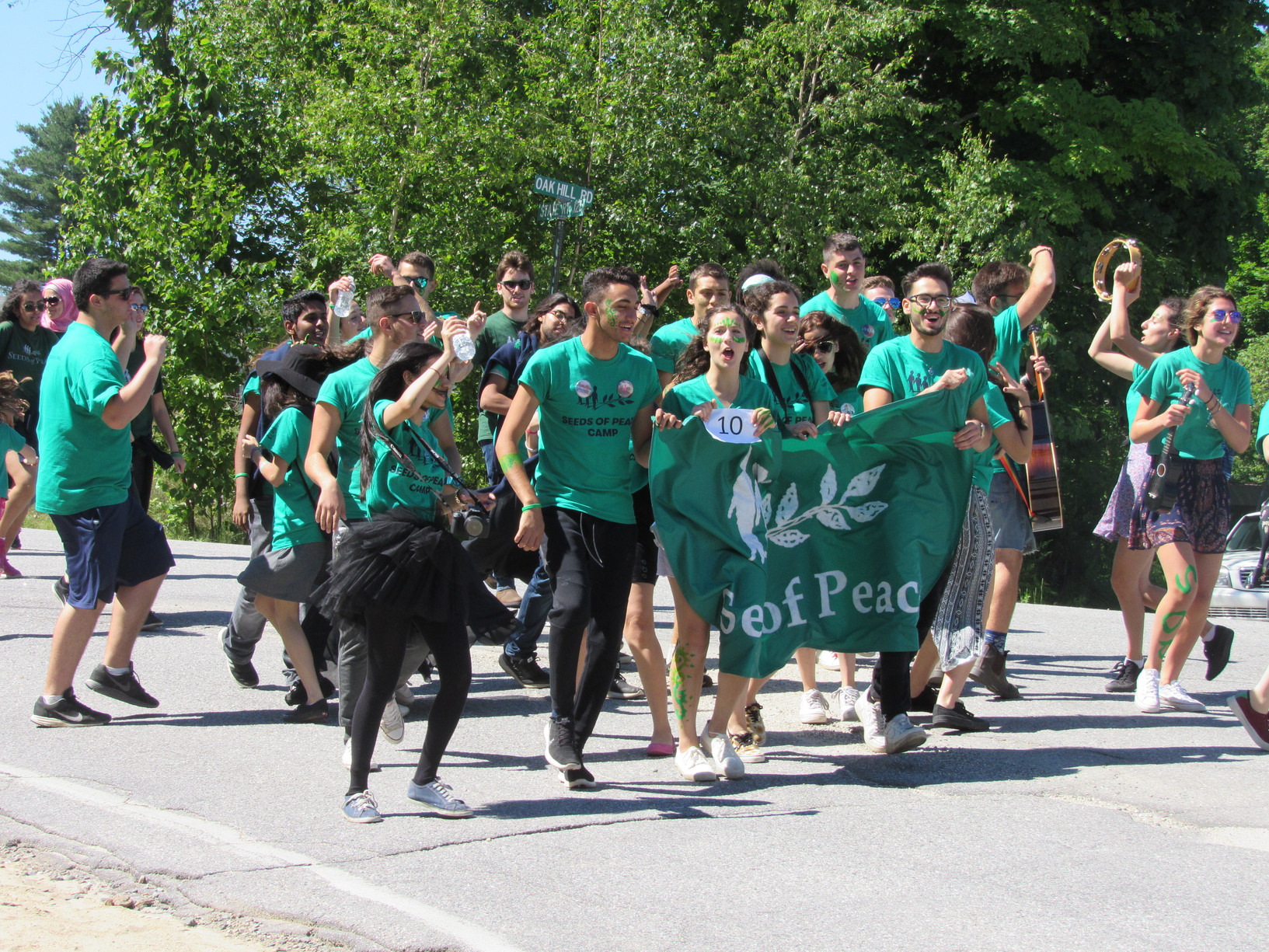 Seeds of Peace marchers carrying a banner at the Fourth of July parade.