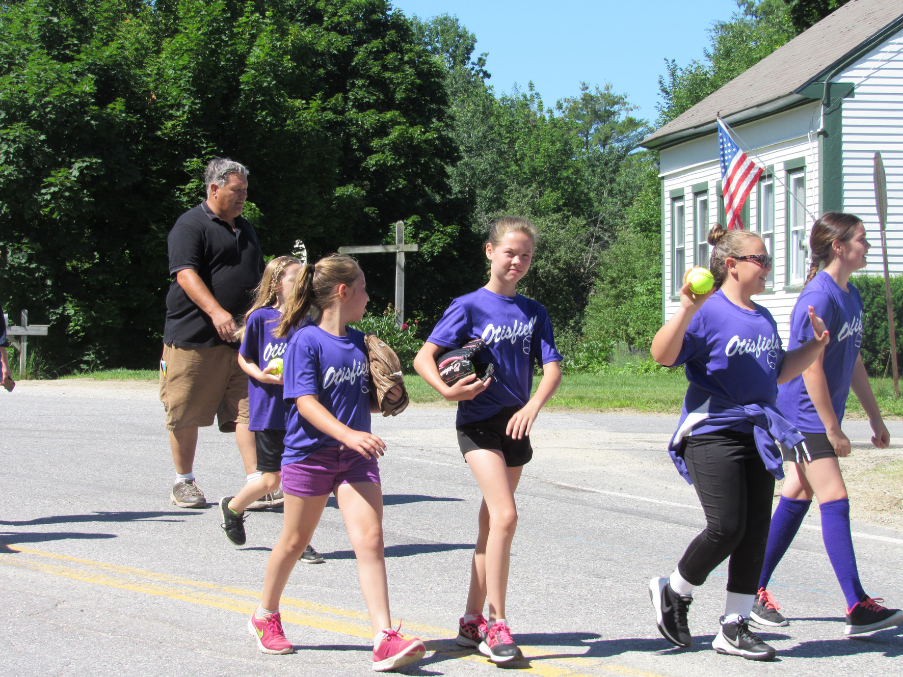 Young players in purple Otisfield shirts at the Fourth of July parade.