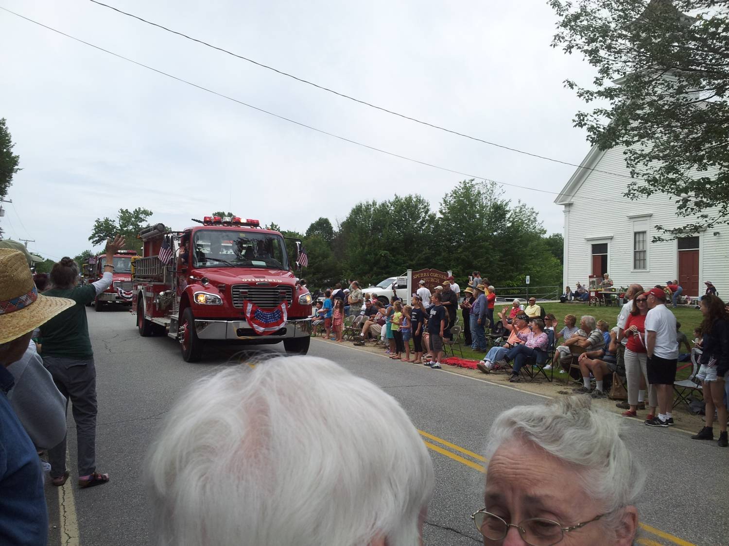 Red fire engine in the parade at the Fourth of July parade.
