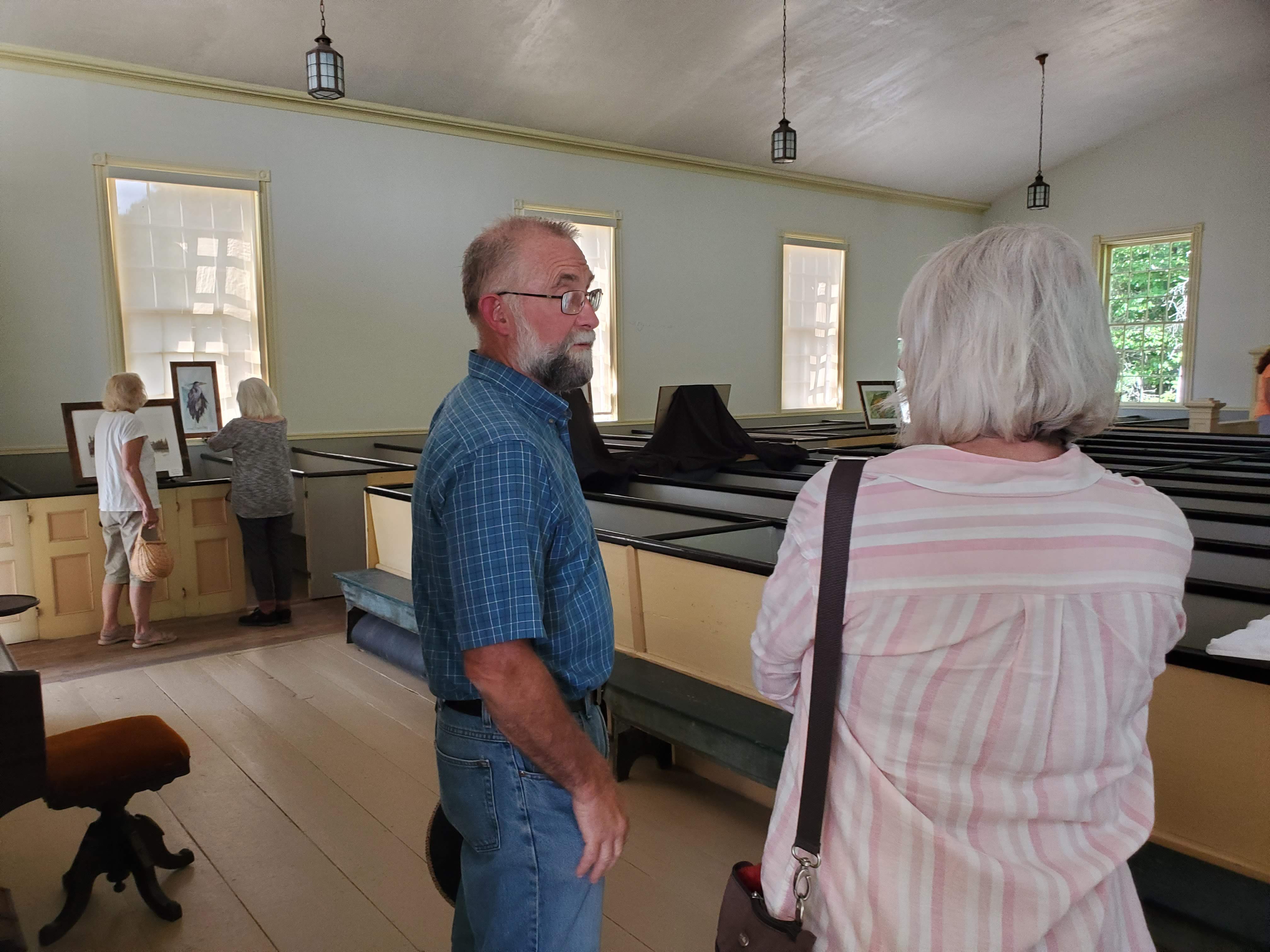 Visitors and displays inside the meetinghouse