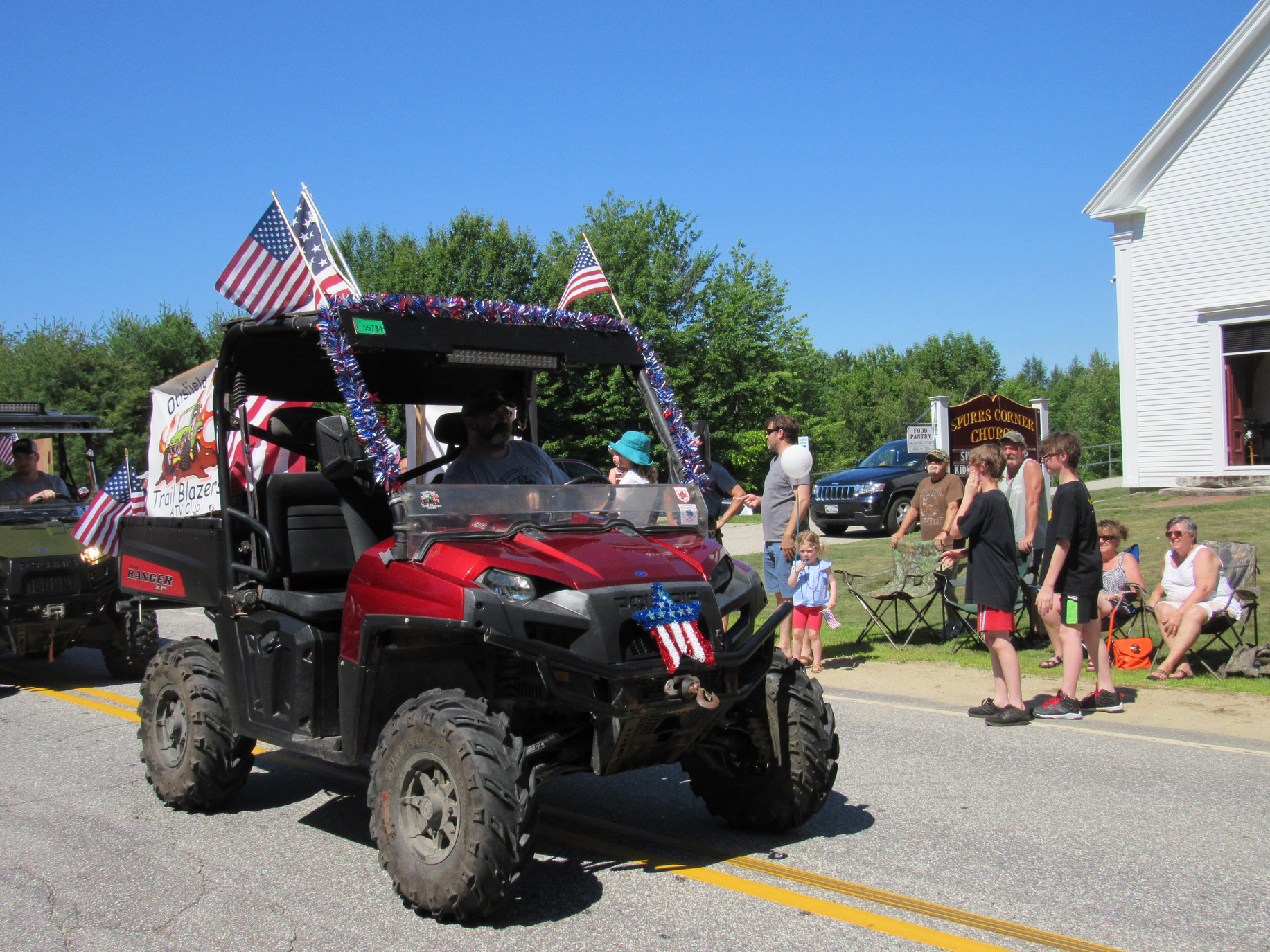 Side-by-side utility vehicle in the parade at the Fourth of July parade.