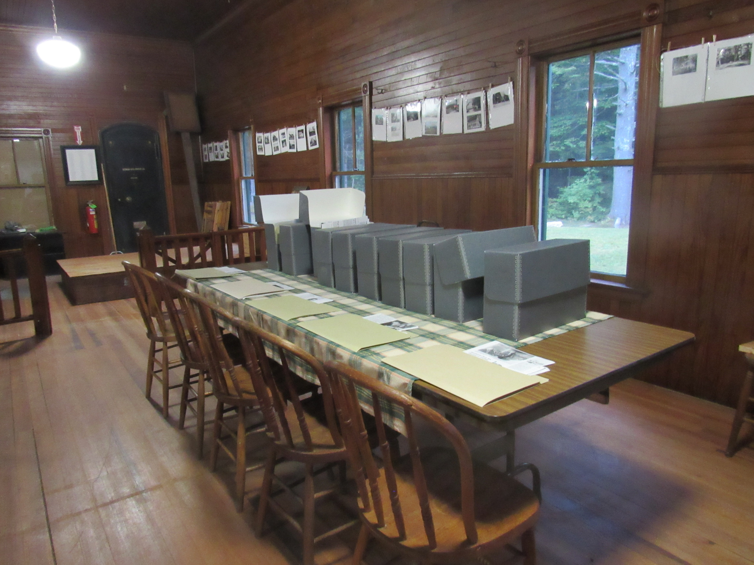 Archive boxes and papers arranged on tables