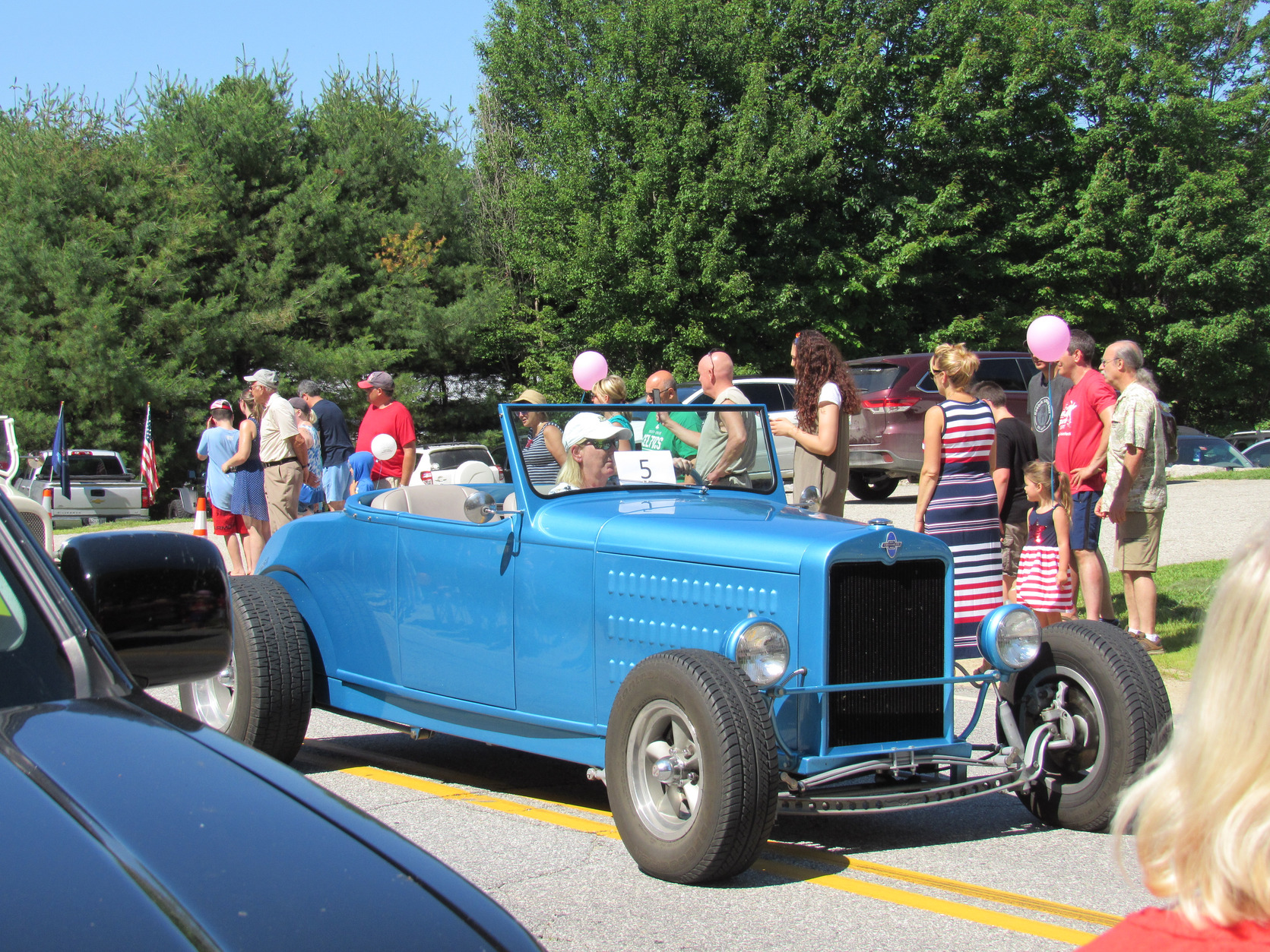 Blue open-top hot rod at the Fourth of July parade.