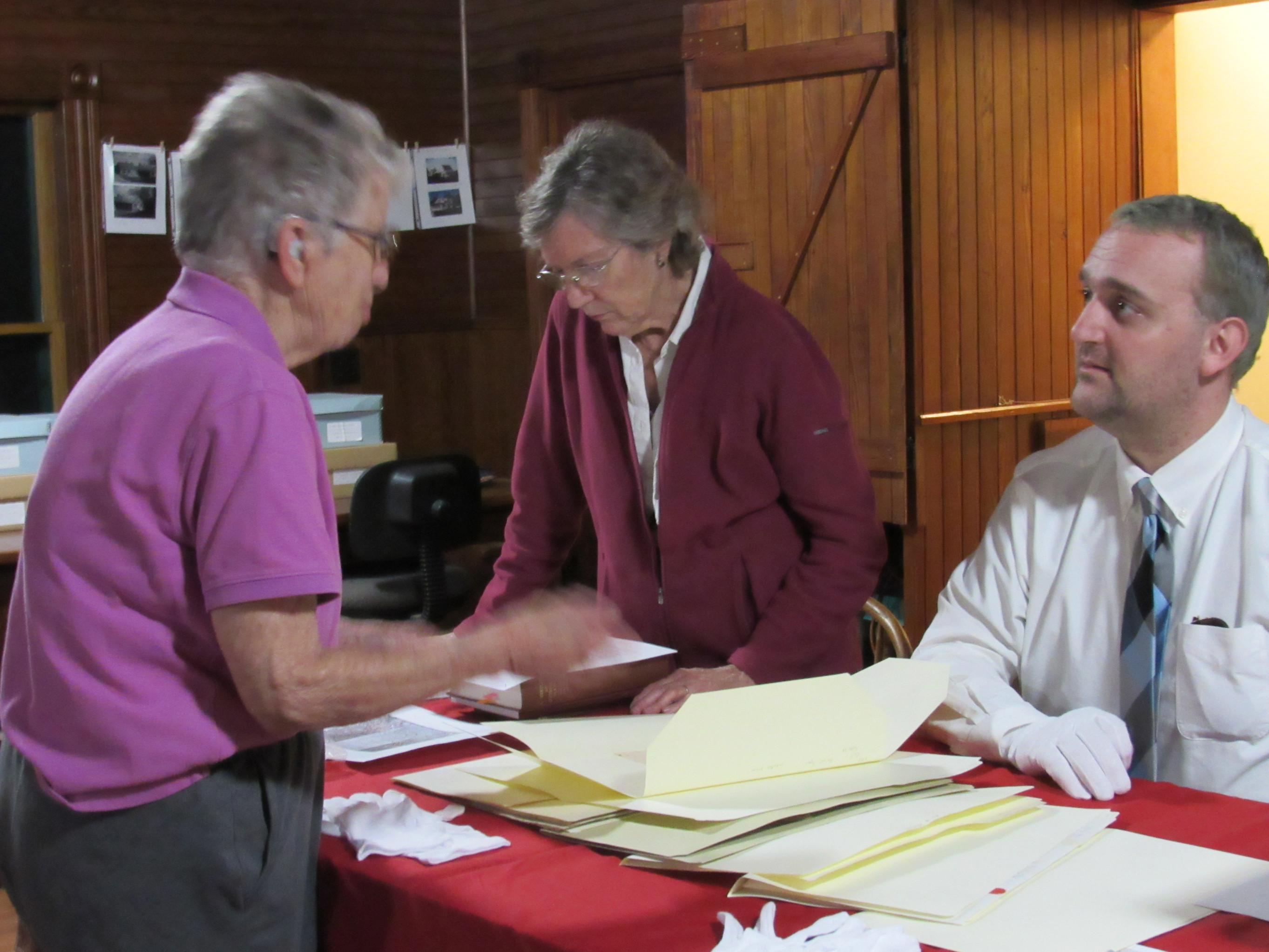 Visitors examining historical society archives