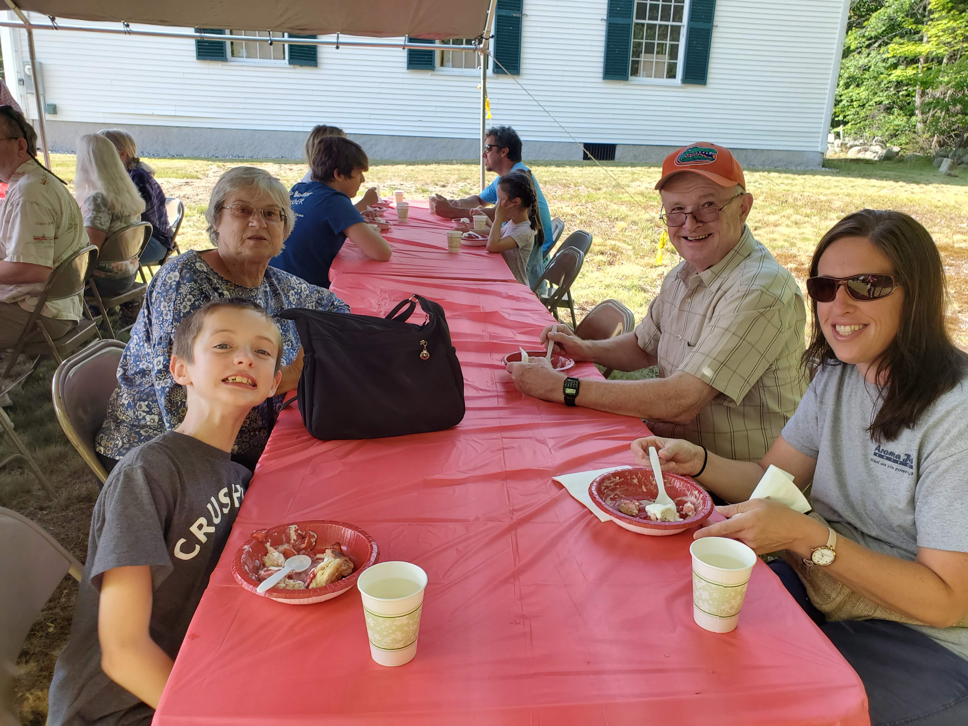 Guests gathered outdoors for refreshments at the Strawberry Festival at Bell Hill Meetinghouse.