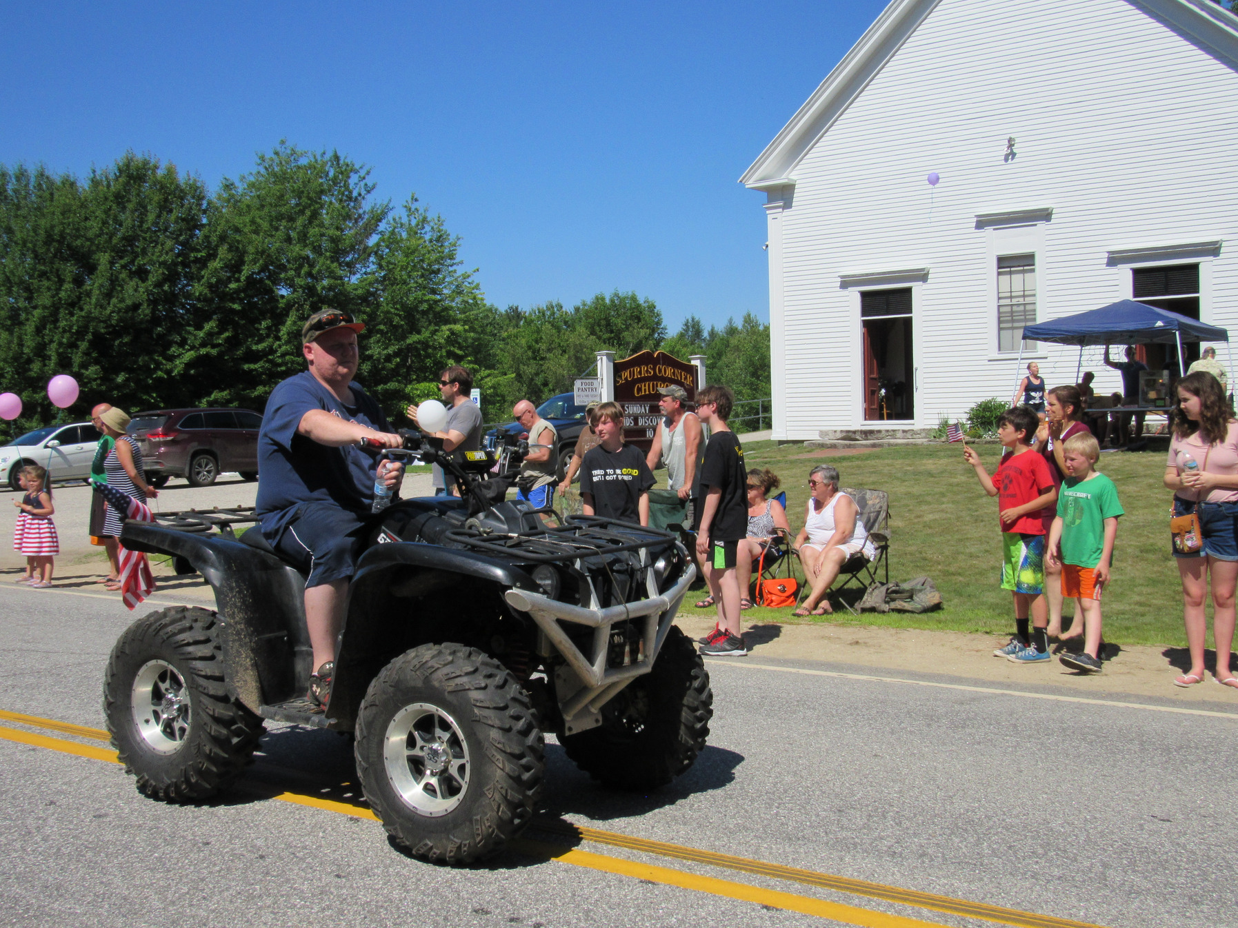 Four-wheel ATV in the parade at the Fourth of July parade.