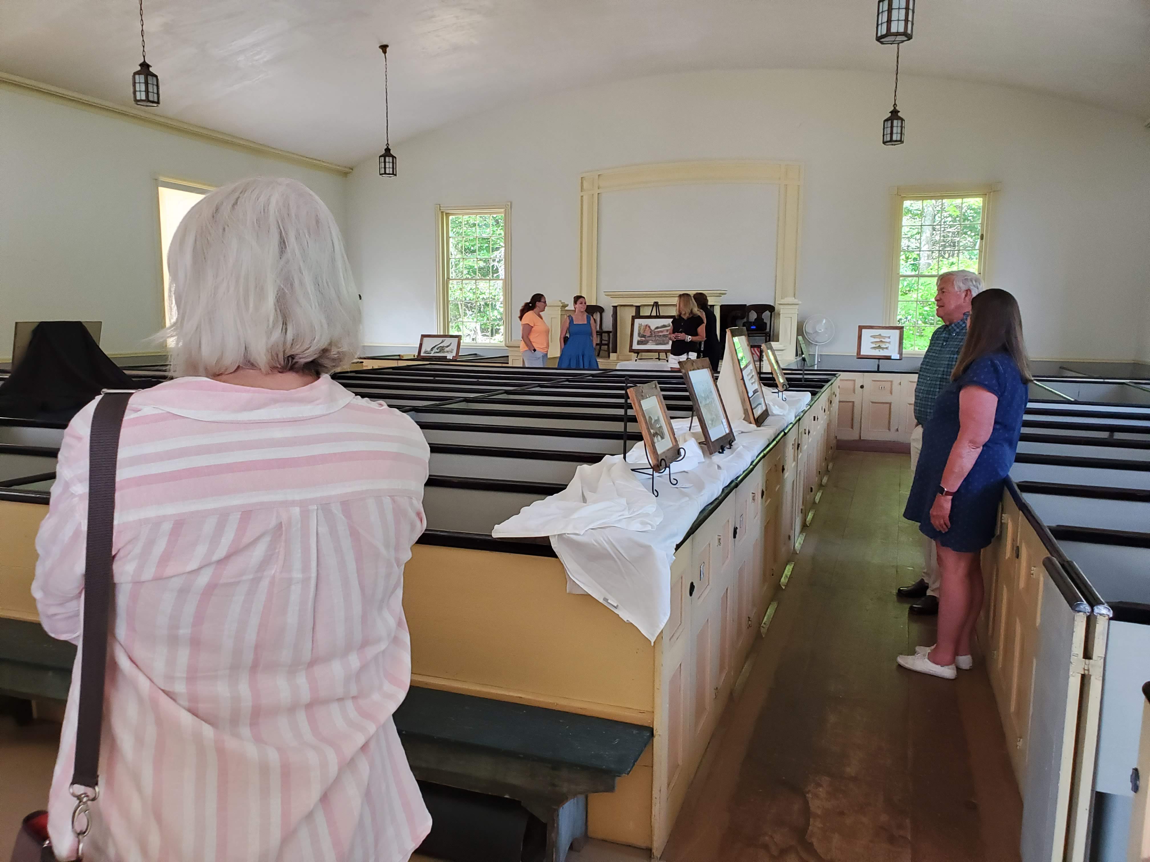 Visitors and displays inside the meetinghouse
