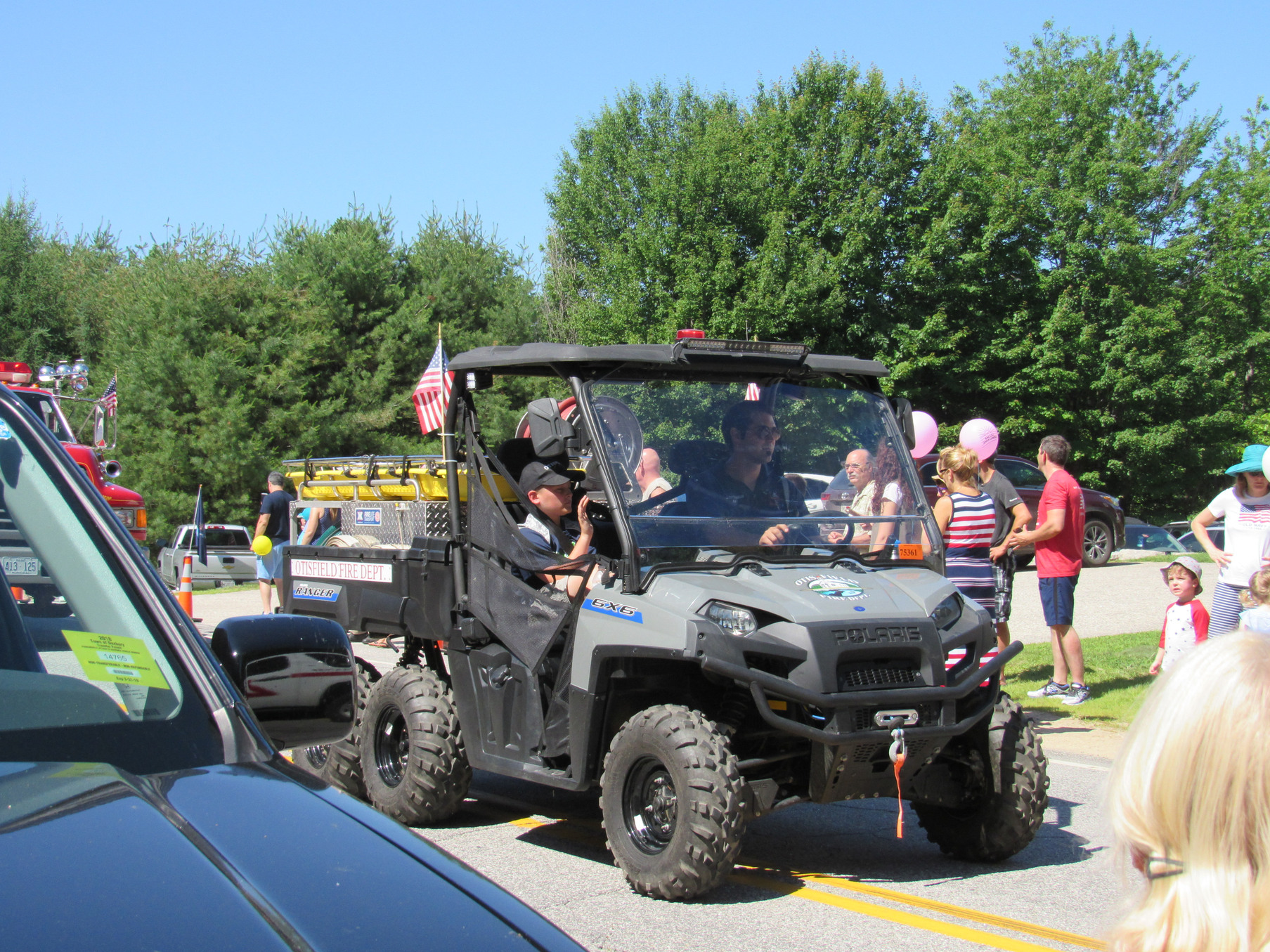 Side-by-side utility vehicle in the parade at the Fourth of July parade.