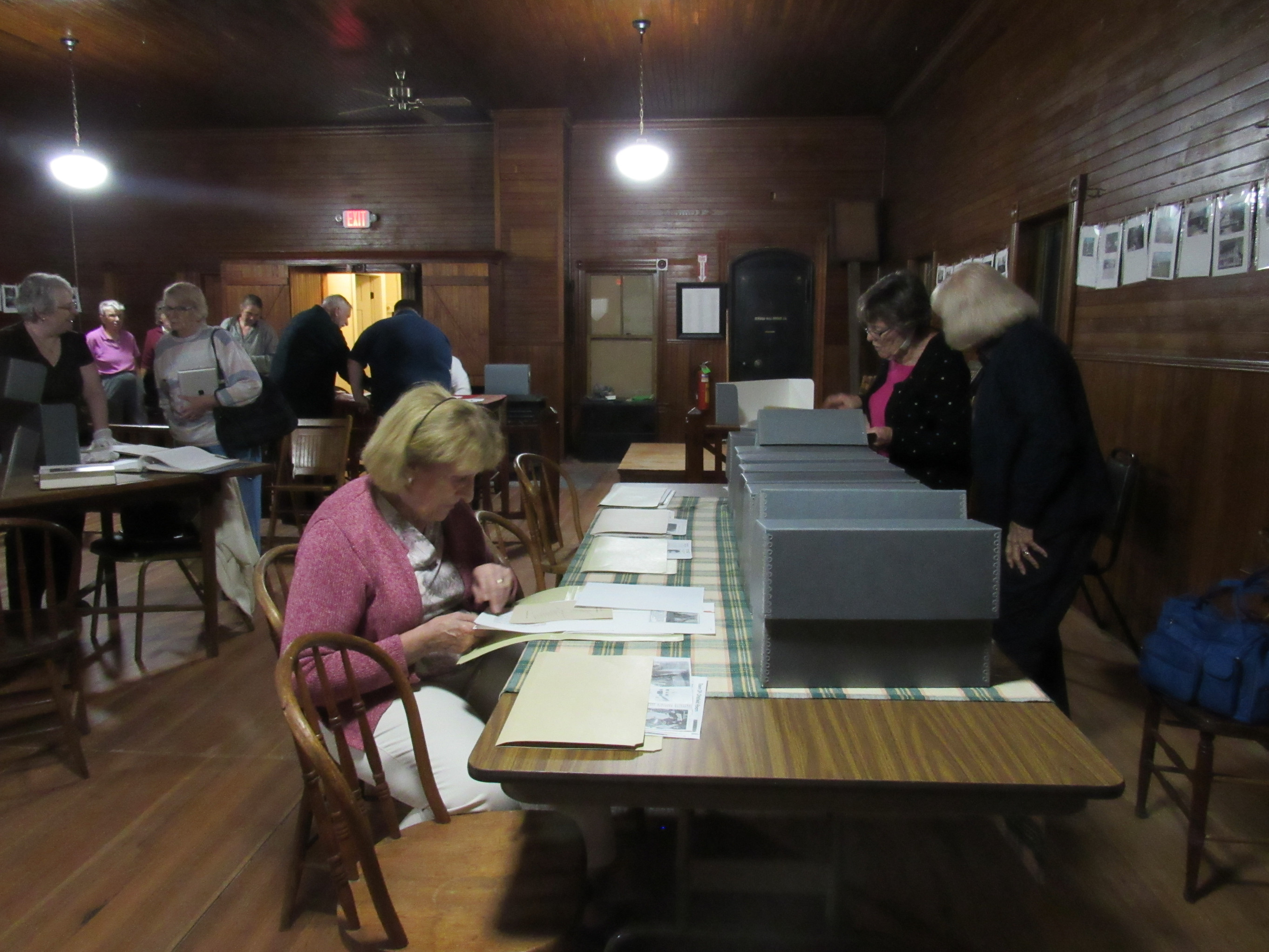 Visitors examining historical society archives