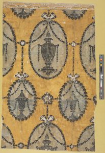 Stenciled wallpaper, circa 1785. Yellow wallpaper with repeated urns, garlands, and borders.