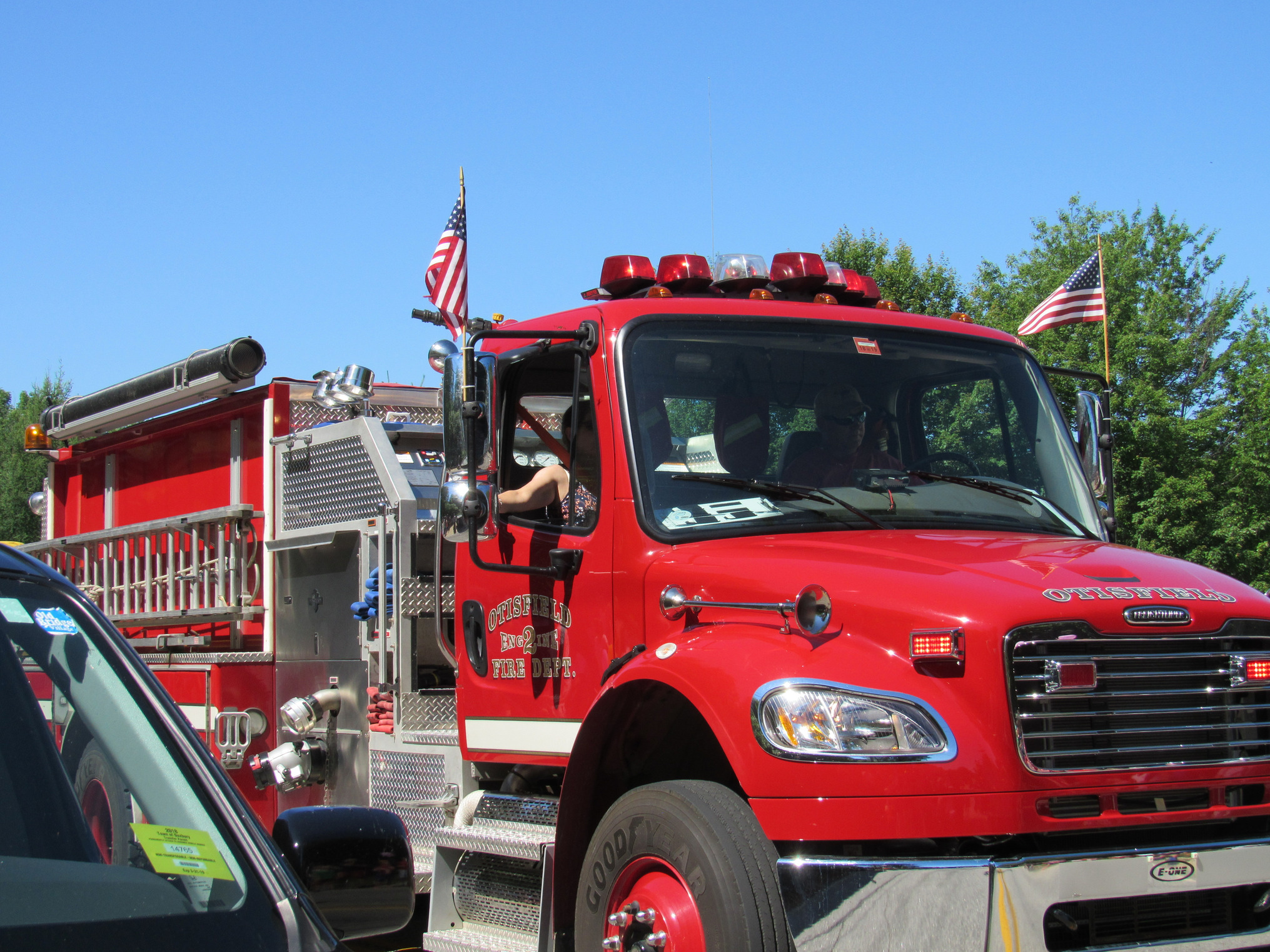 Red fire engine in the parade at the Fourth of July parade.