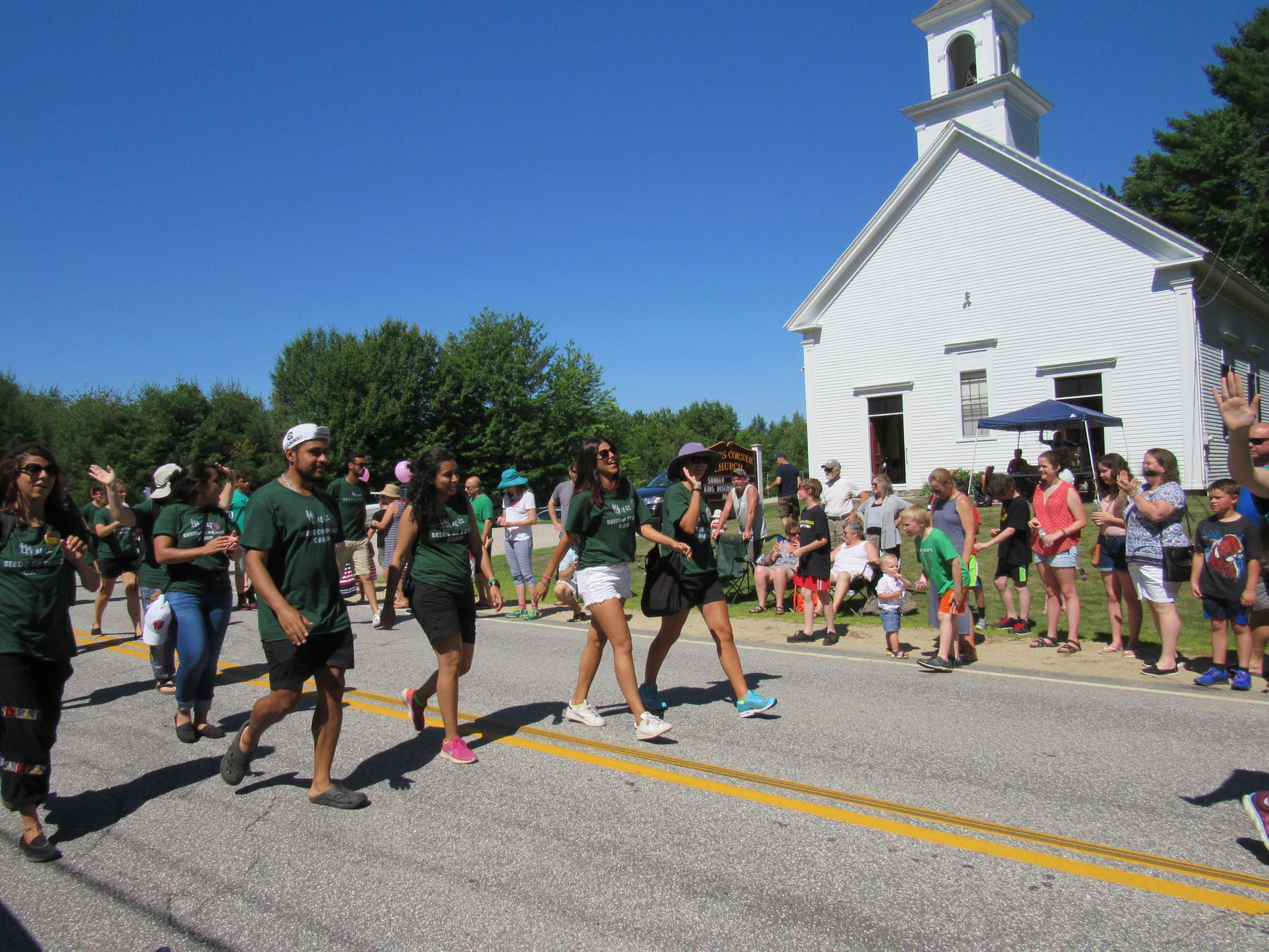 Parade marchers in green shirts at the Fourth of July parade.