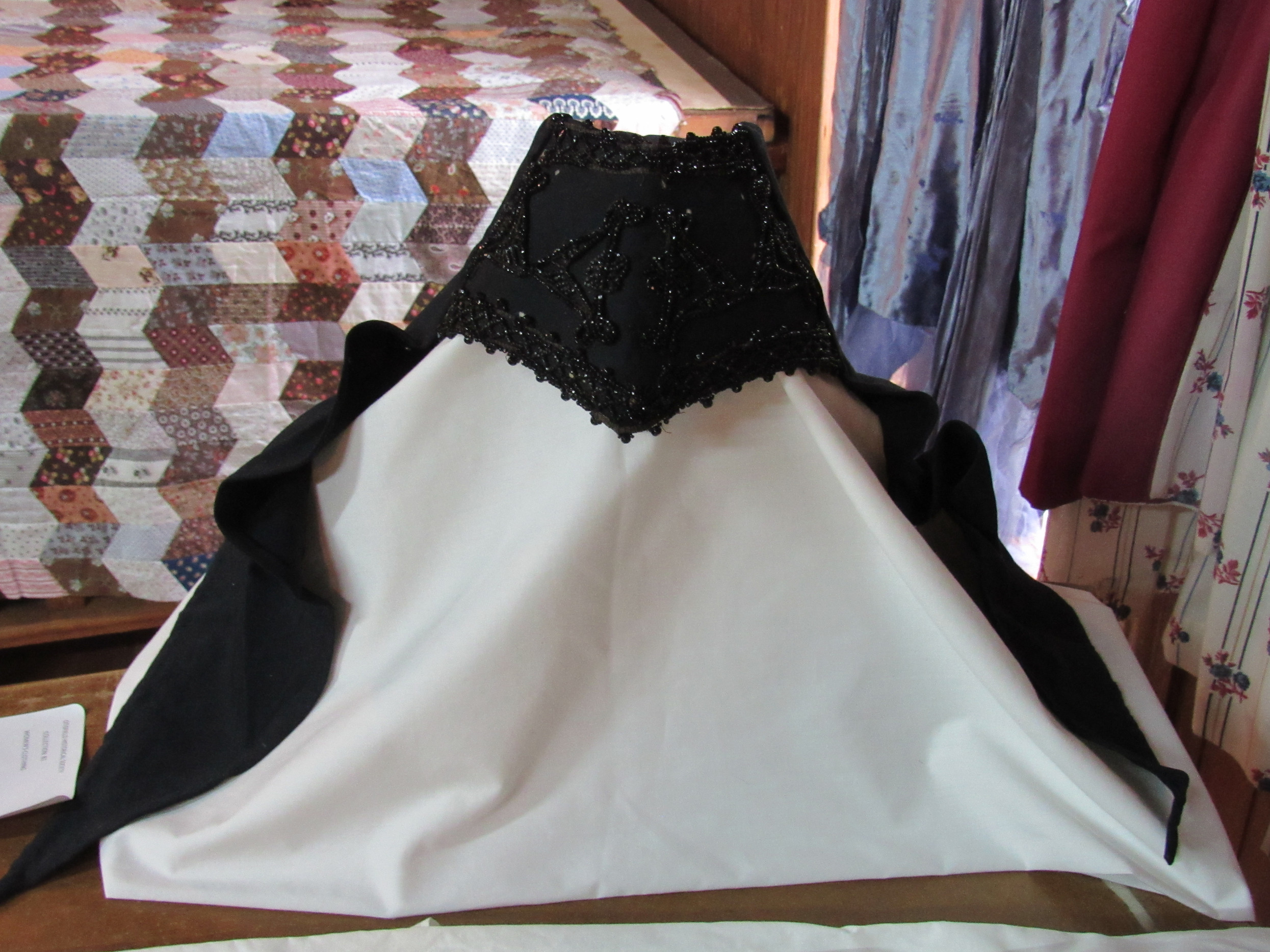 Black beaded clothing accessory at the women's textiles display.