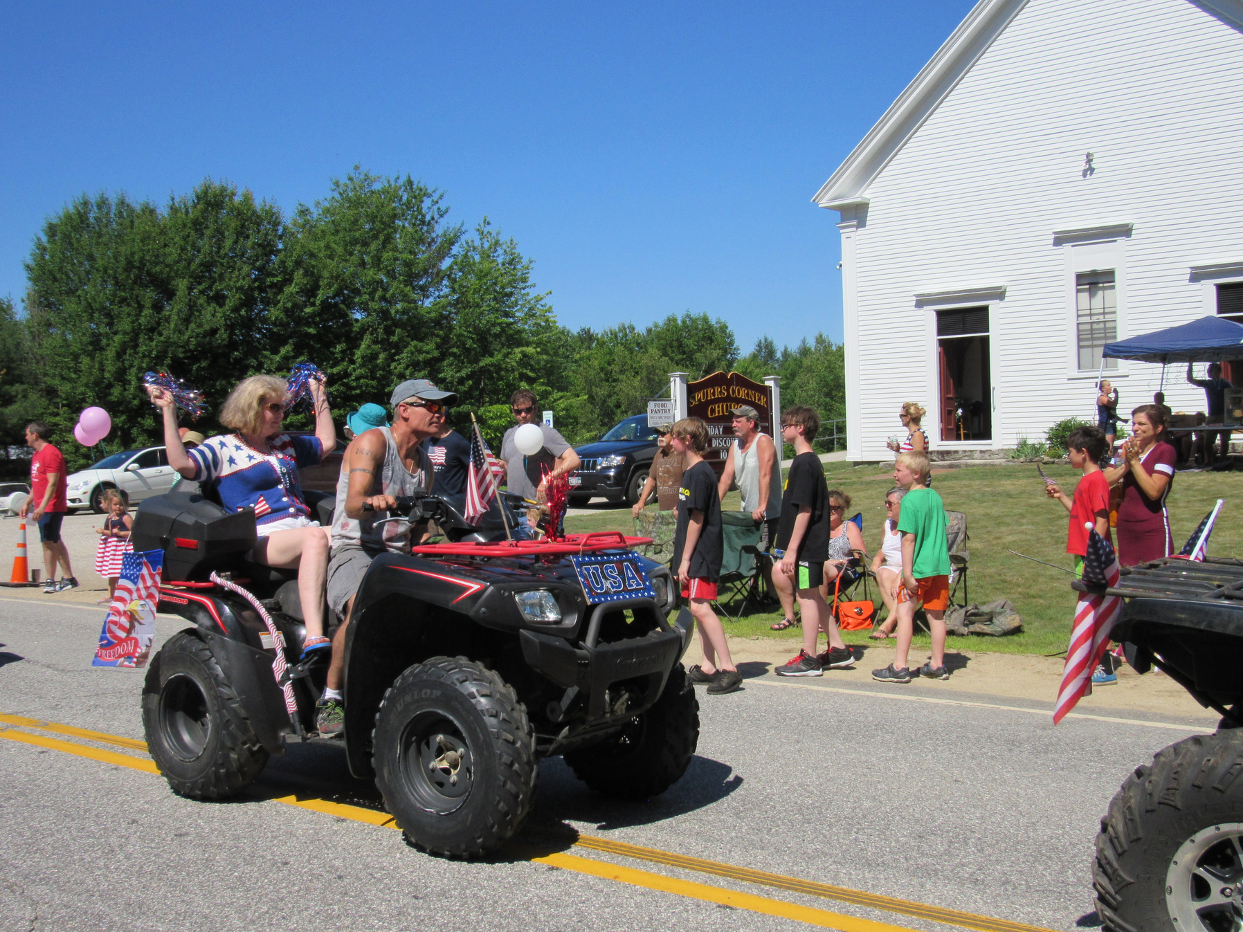 Side-by-side utility vehicle in the parade at the Fourth of July parade.