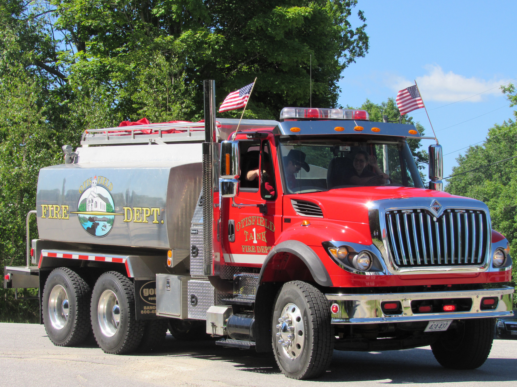 Fire tanker truck passing parade spectators at the Fourth of July parade.