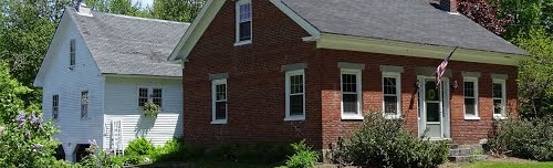 White house and neighboring brick building