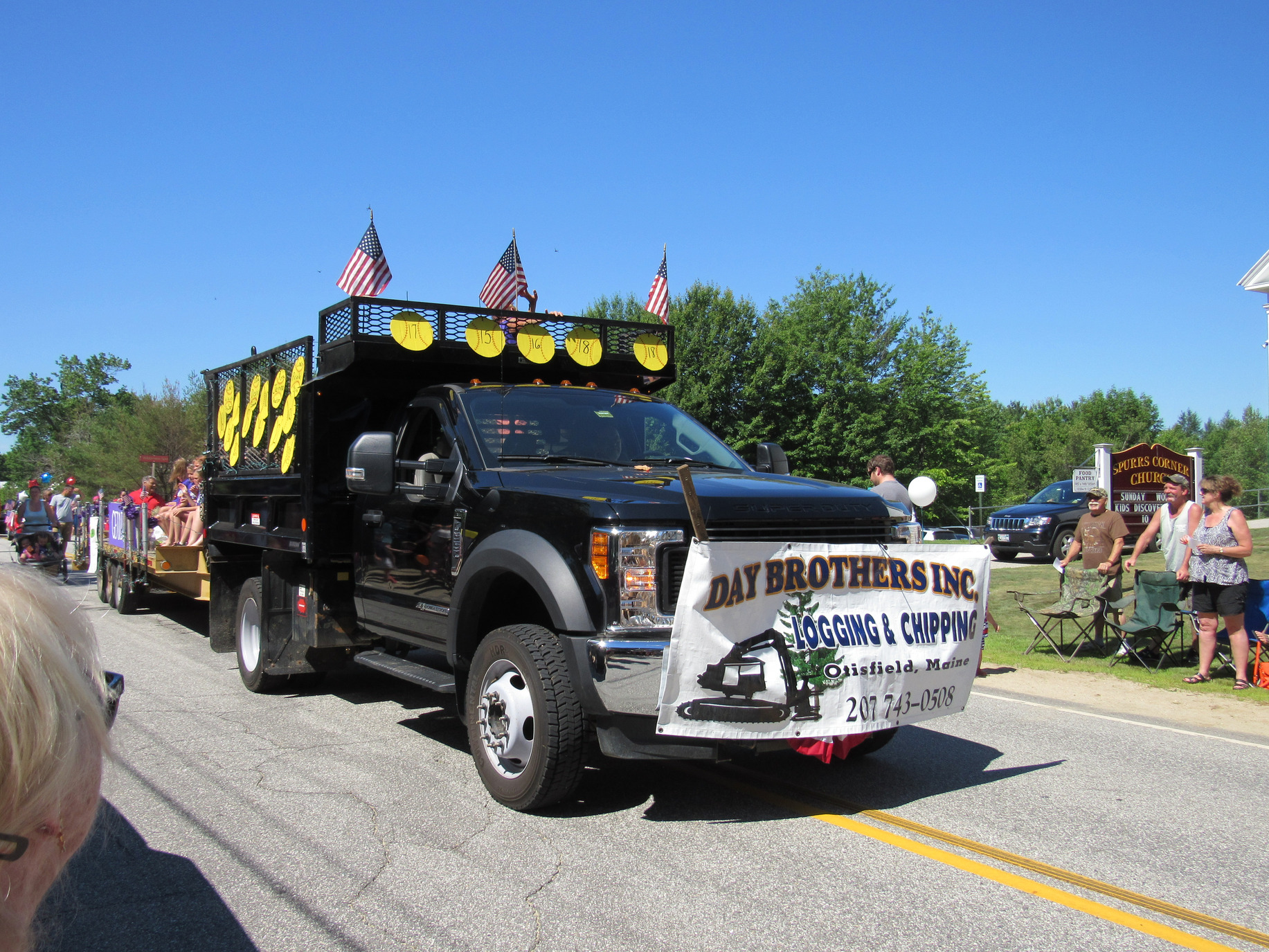 Day Brothers Inc. logging truck with softball decorations at the Fourth of July parade.