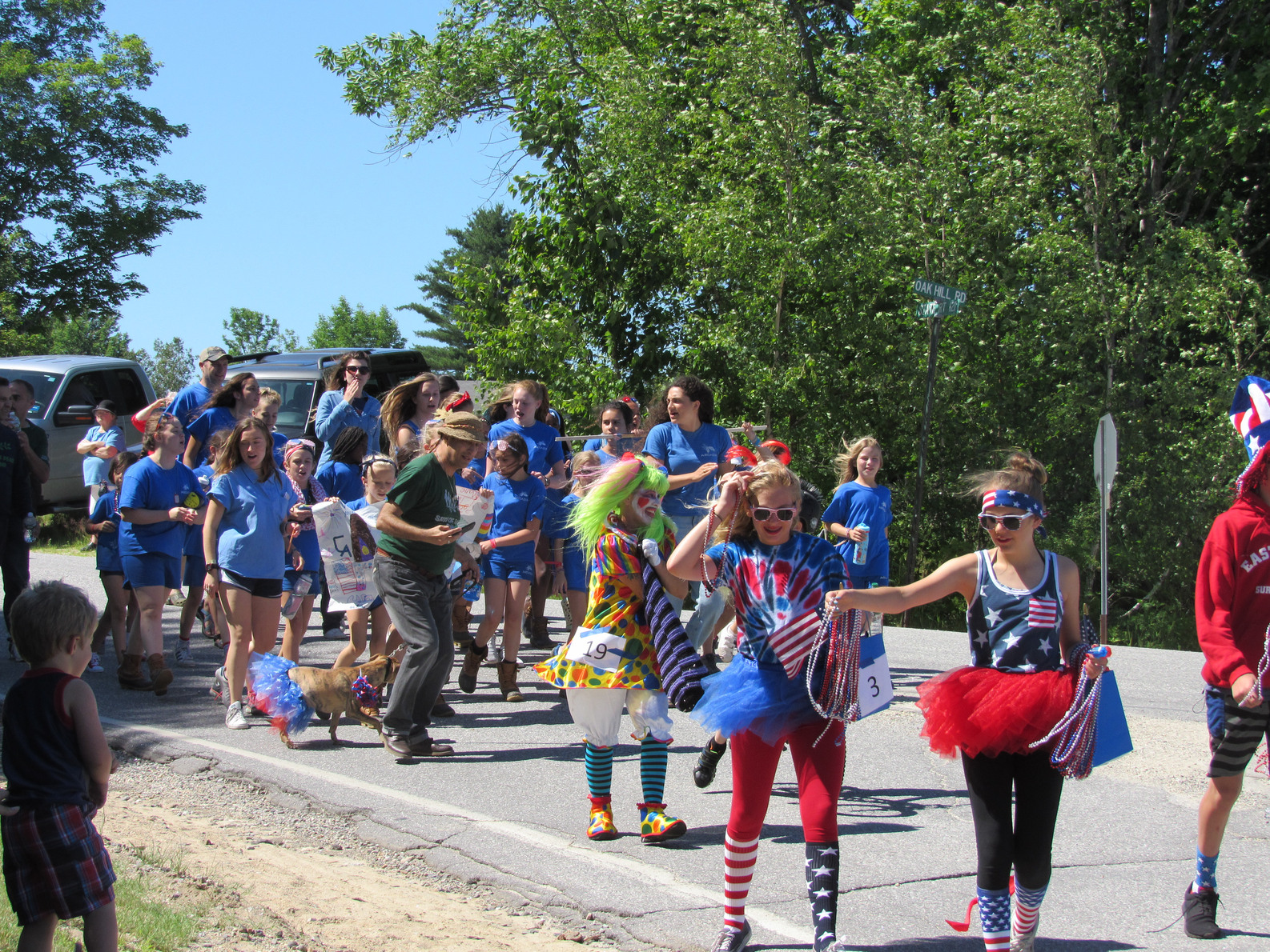 Camp parade marchers dressed in blue at the Fourth of July parade.