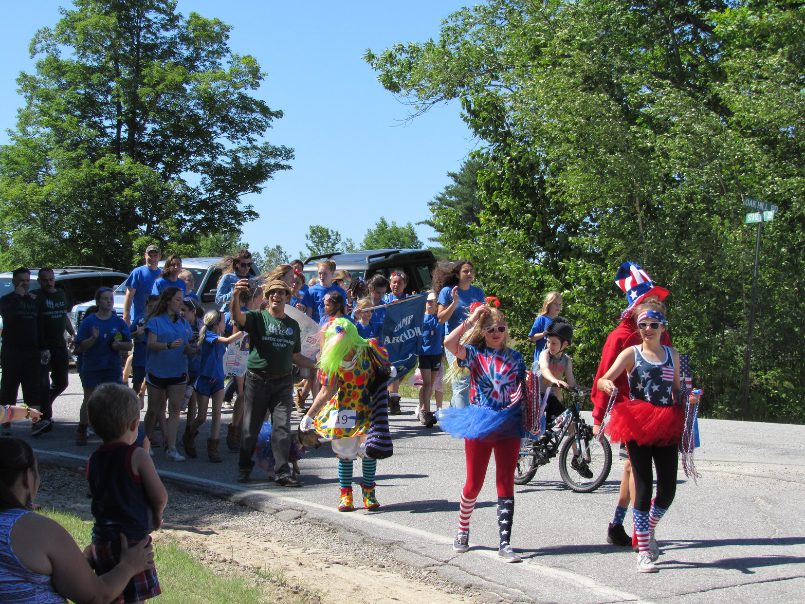 Camp parade marchers dressed in blue at the Fourth of July parade.