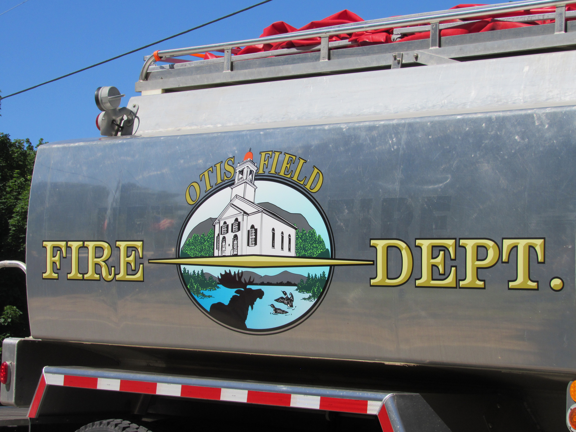 Otisfield Fire Department emblem on a water tanker at the Fourth of July parade.