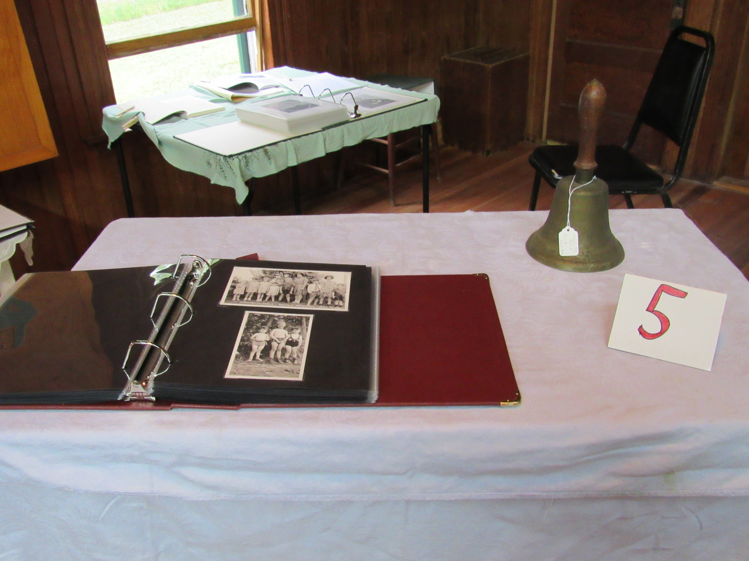Photograph album and archival papers on display