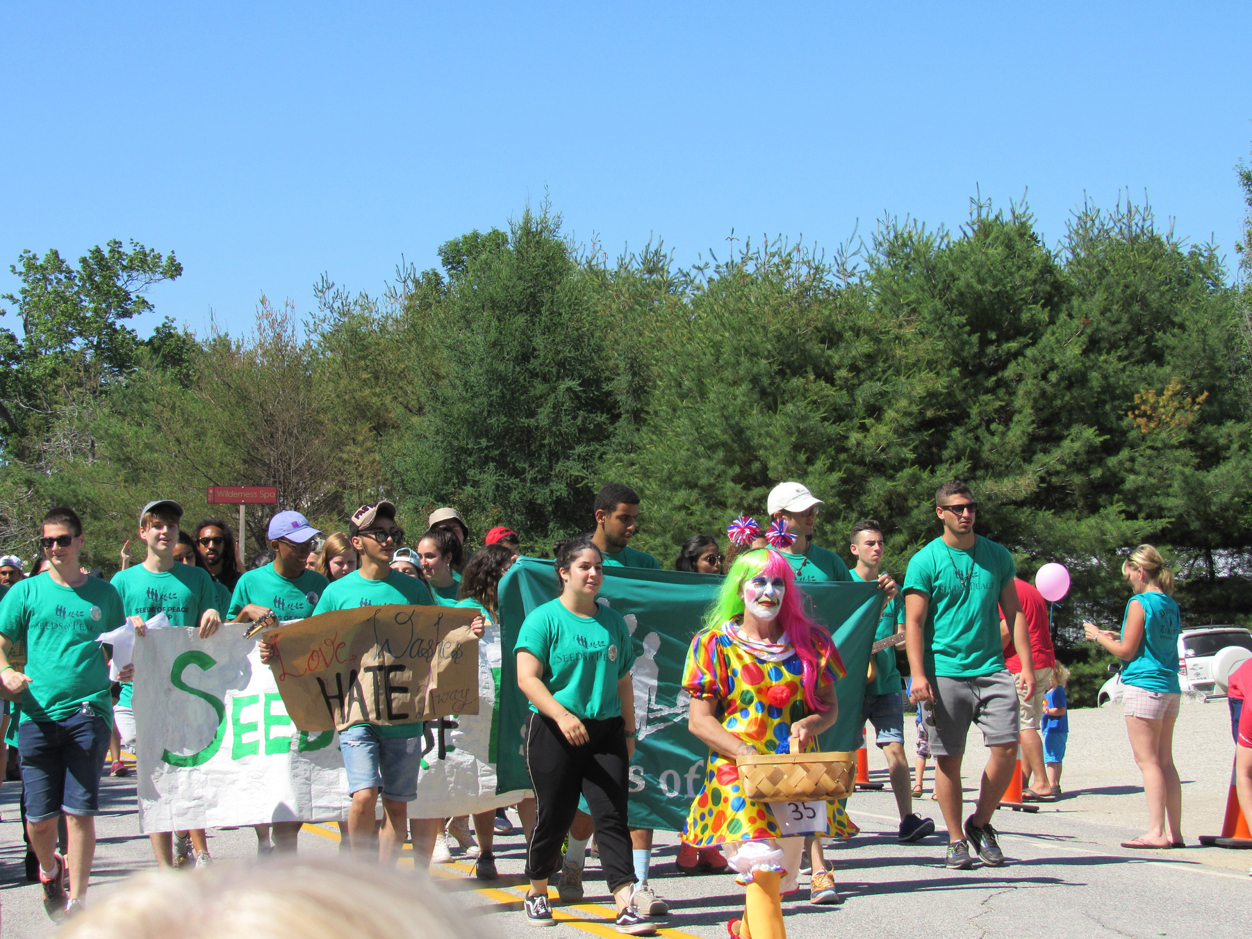 Seeds of Peace marchers carrying a banner at the Fourth of July parade.