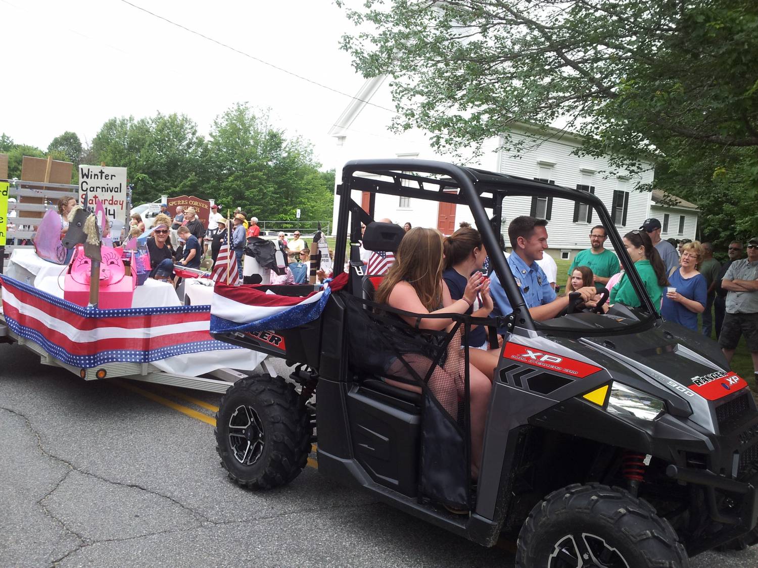 Side-by-side utility vehicle in the parade at the Fourth of July parade.