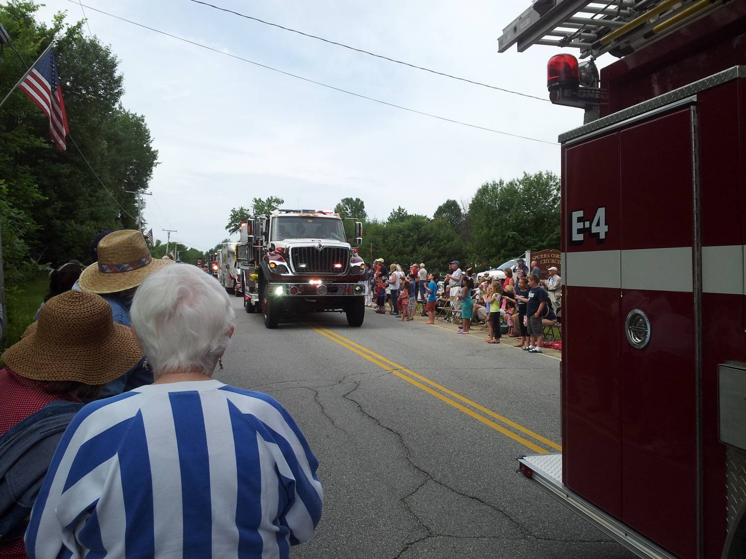 Red fire engine in the parade at the Fourth of July parade.