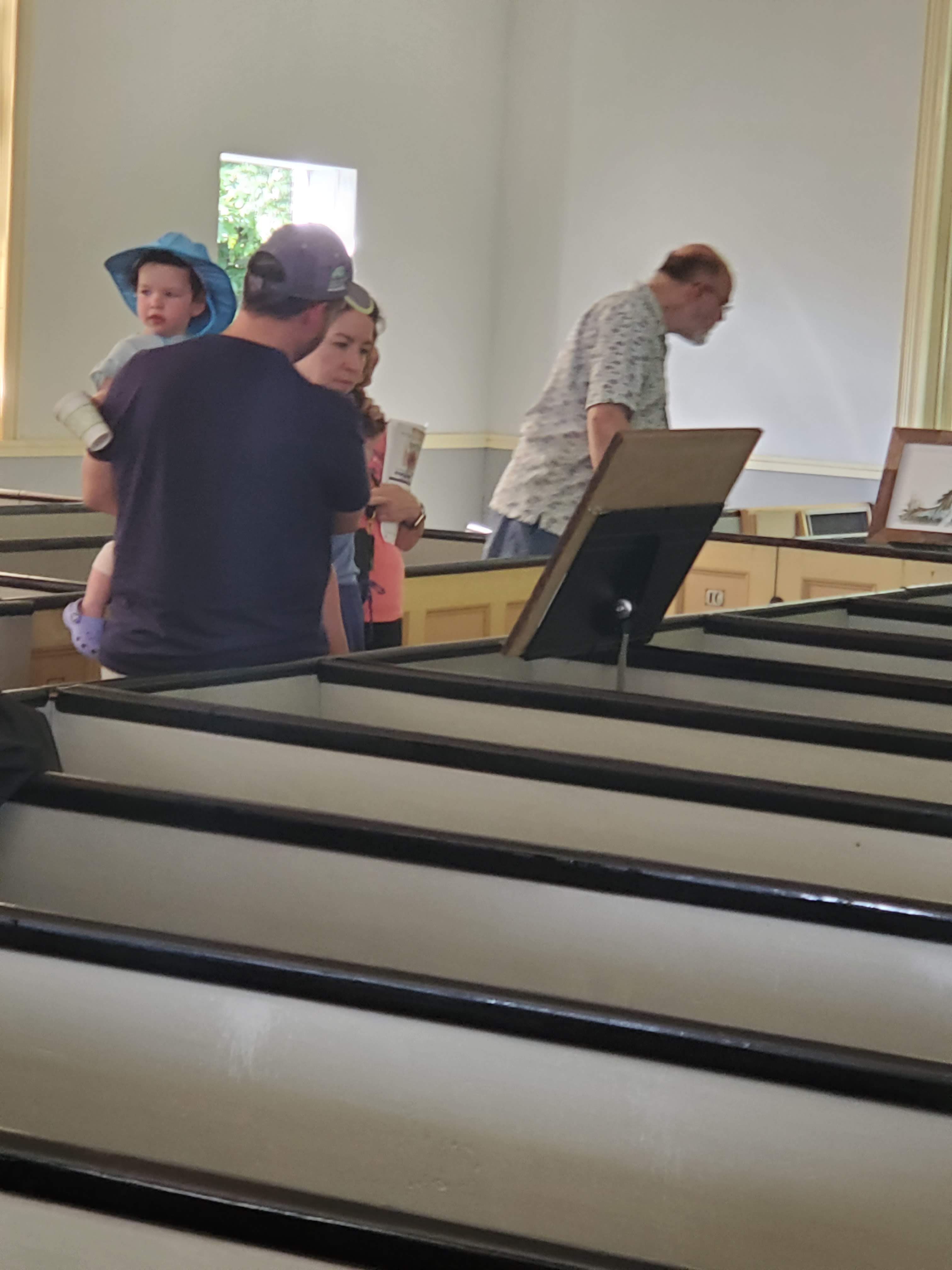 Visitors and displays inside the meetinghouse