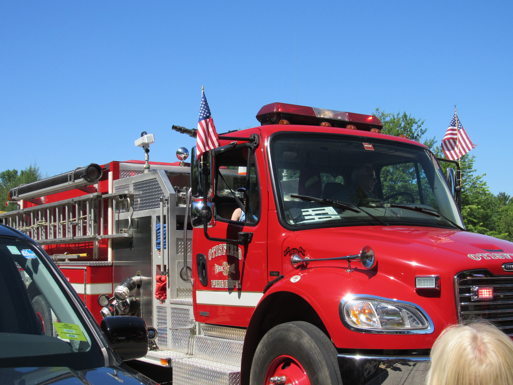 Red fire engine in the parade at the Fourth of July parade.