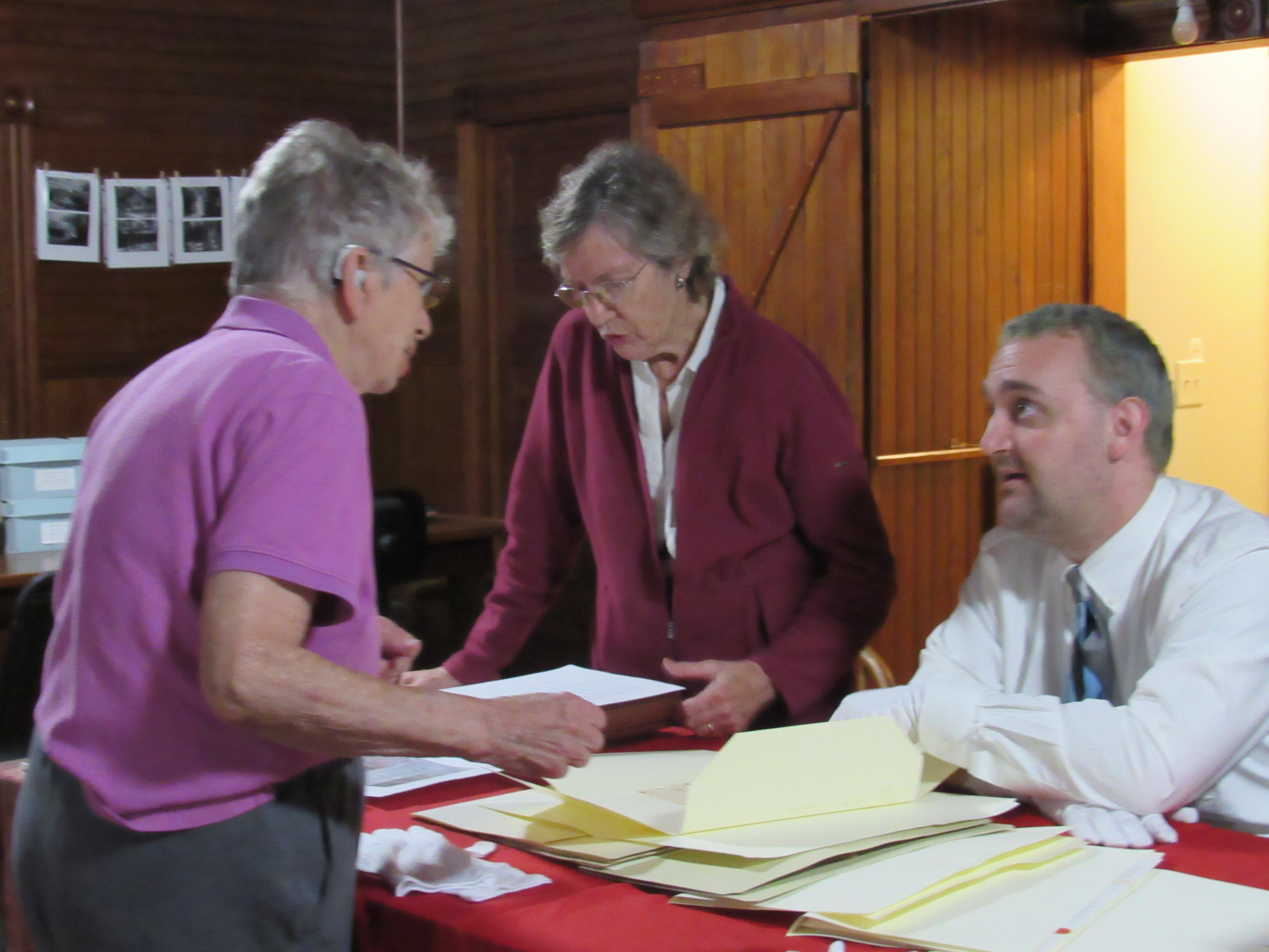 Visitors examining historical society archives