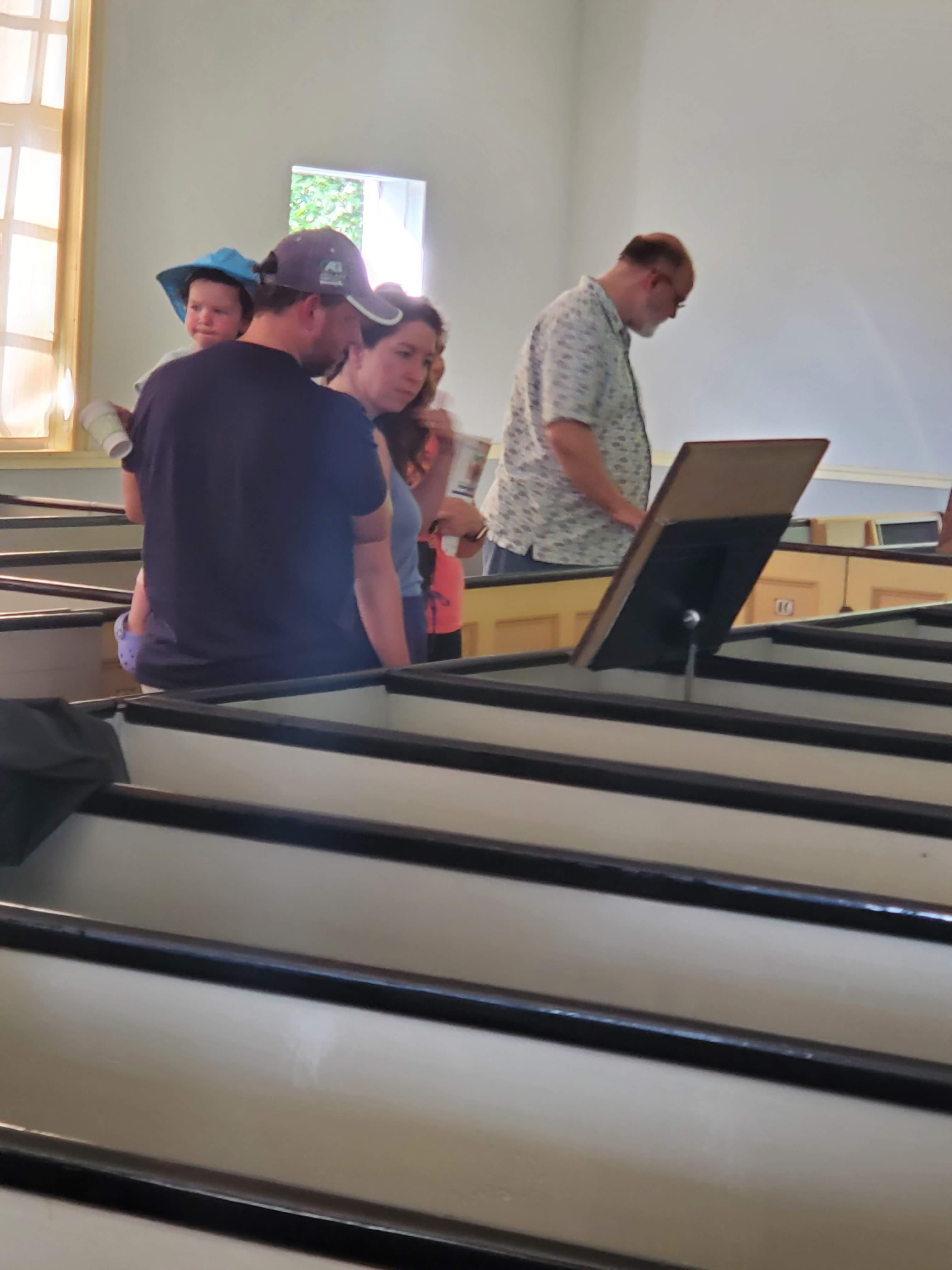 Visitors and displays inside the meetinghouse