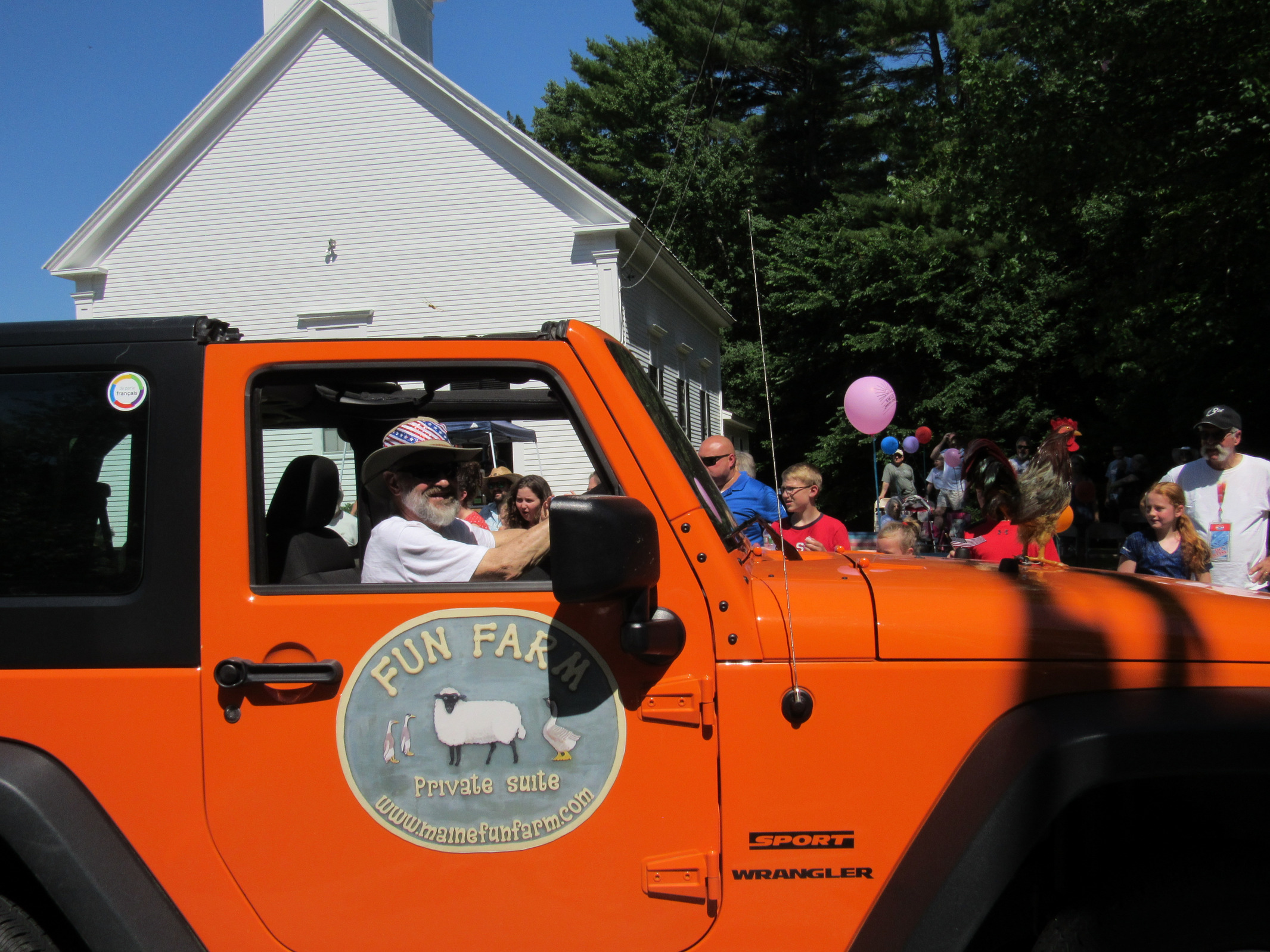 Fun Farm orange Jeep Wrangler at the Fourth of July parade.