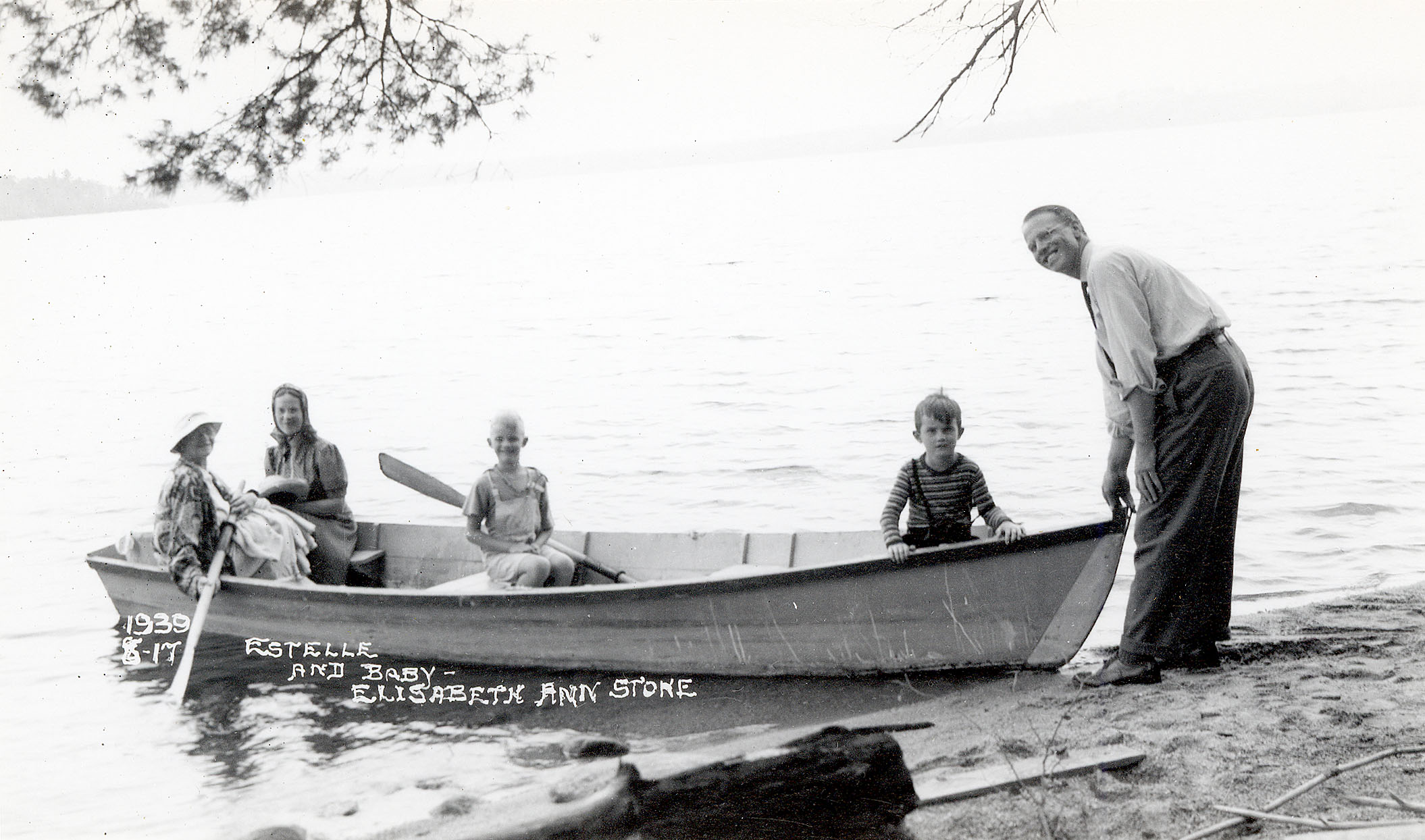 Unloading “Miss America” summer 1939, Left to right are Annette Pottle (?), Estelle Stone holding baby Elizabeth Anne, then Chris and Sam, with Fred Pottle holding boat