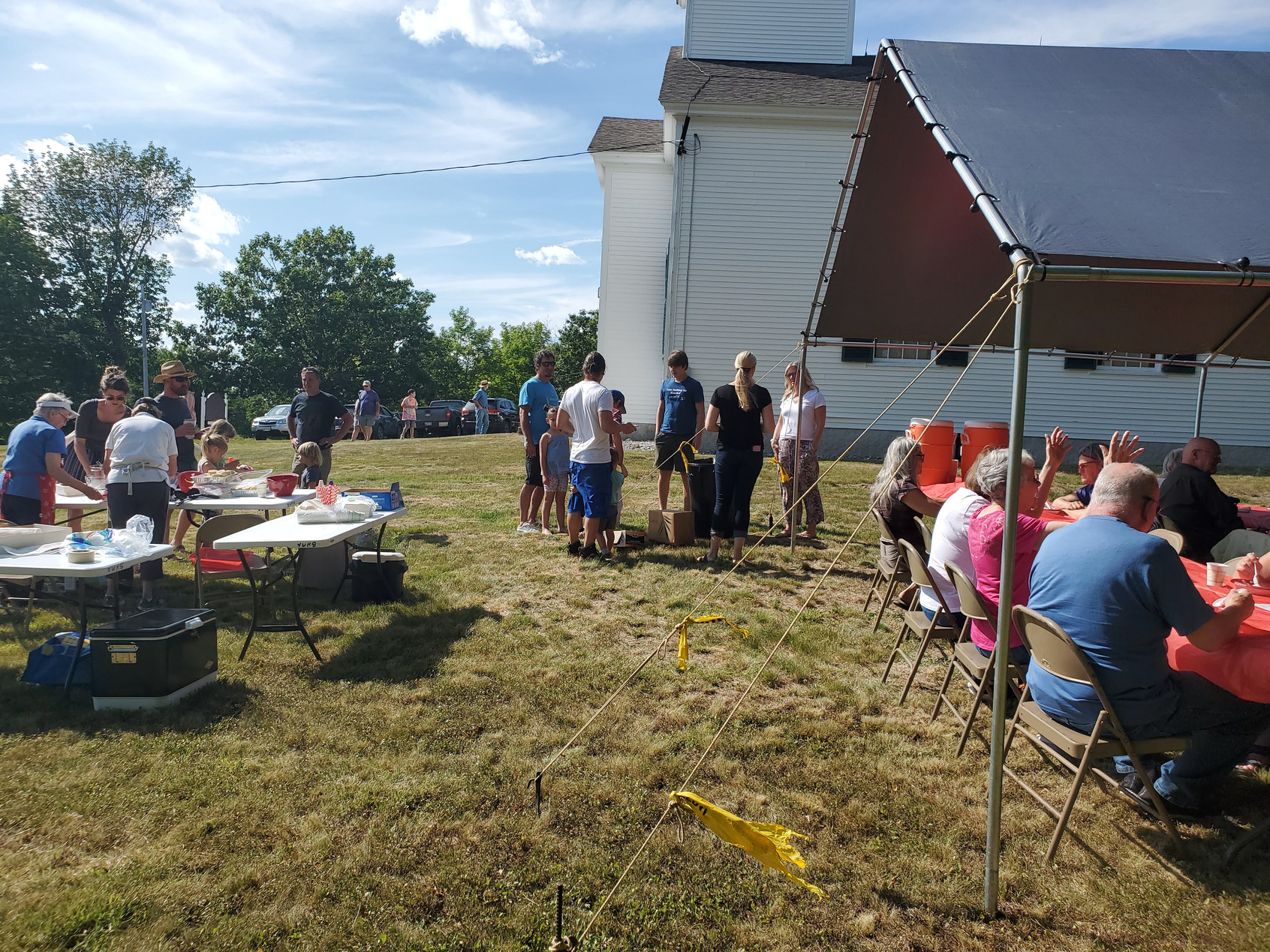 Guests gathered outdoors for refreshments at the Strawberry Festival at Bell Hill Meetinghouse.