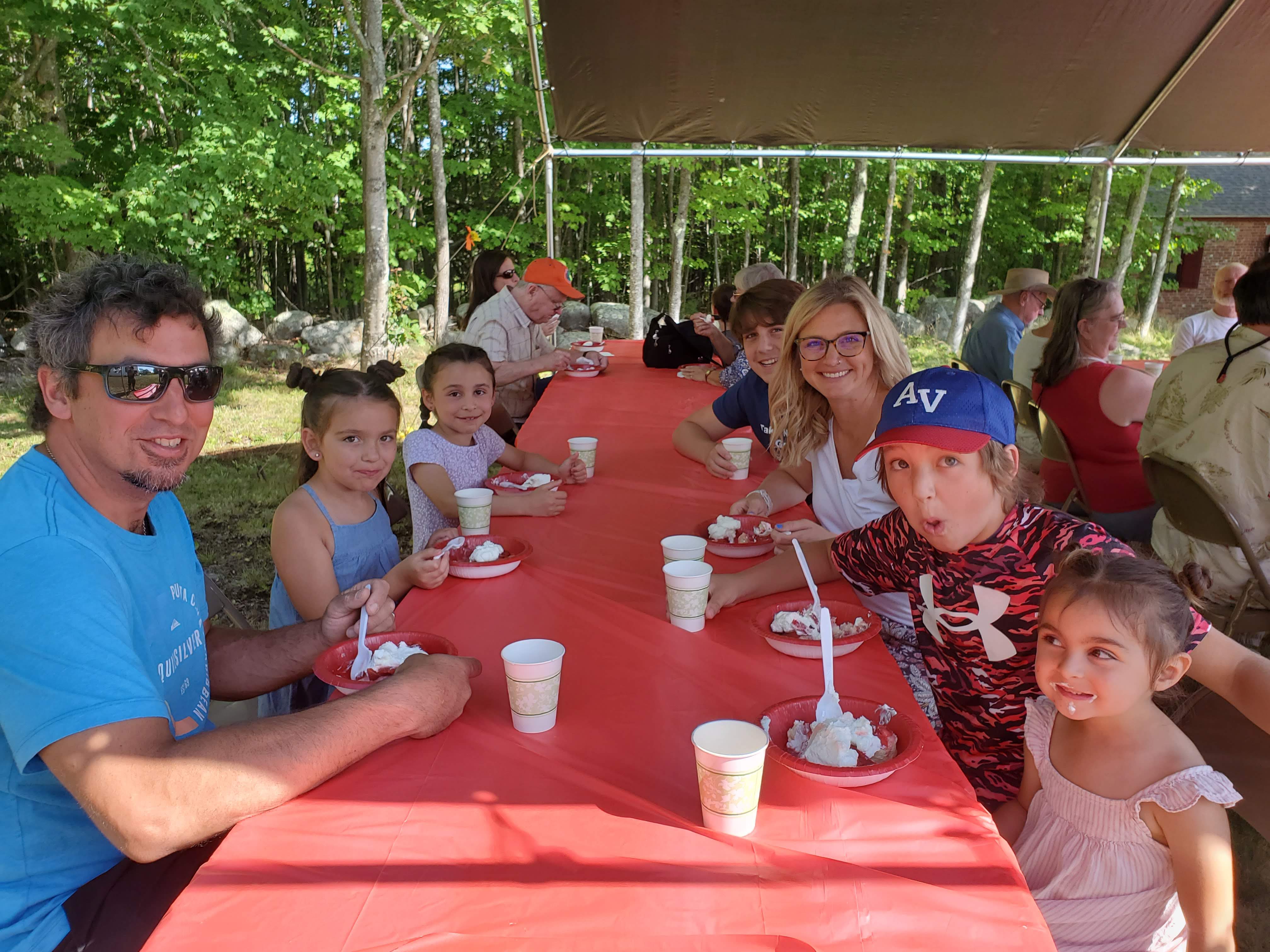 Guests gathered outdoors for refreshments at the Strawberry Festival at Bell Hill Meetinghouse.