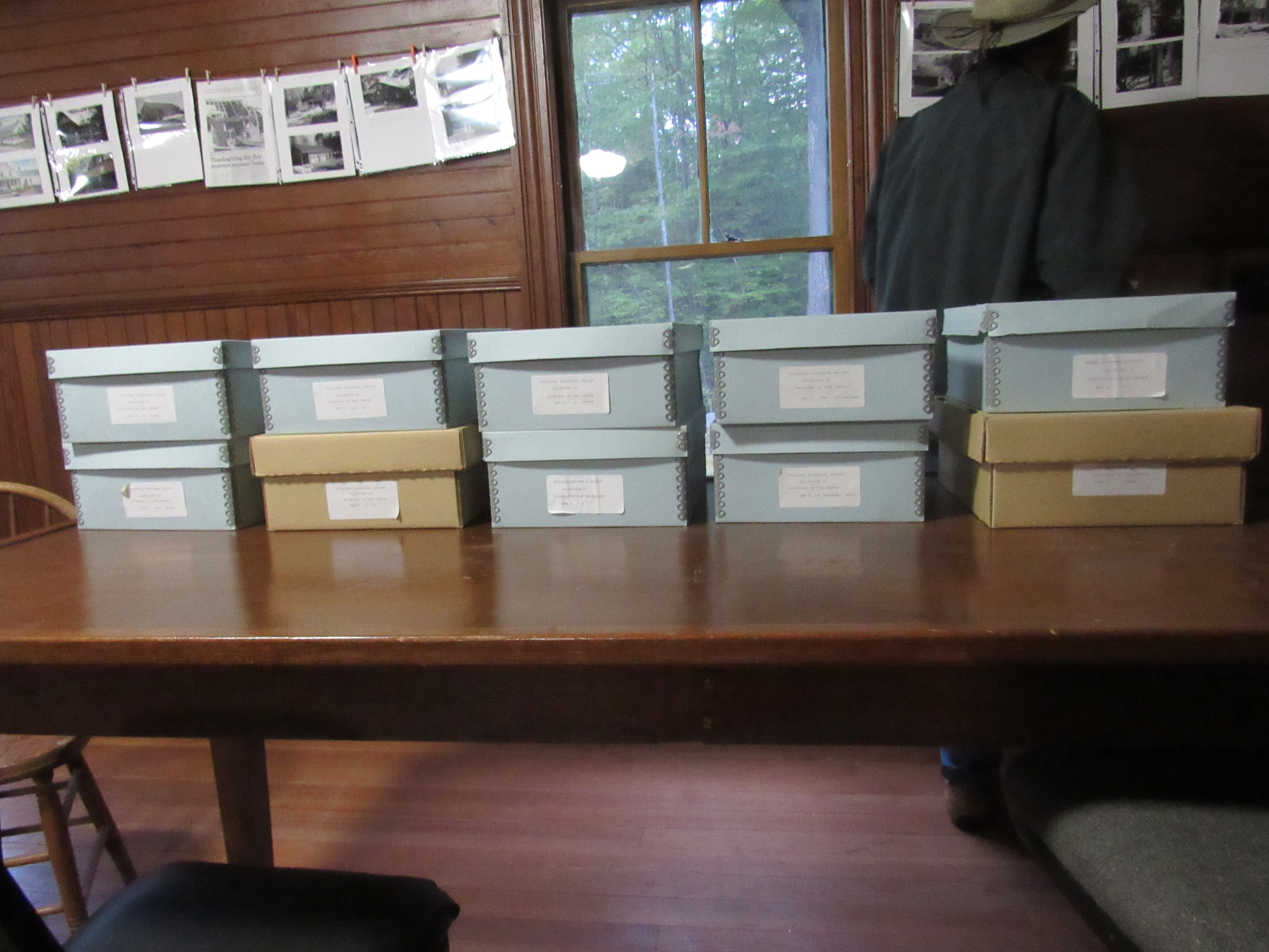 Archive boxes and papers arranged on tables