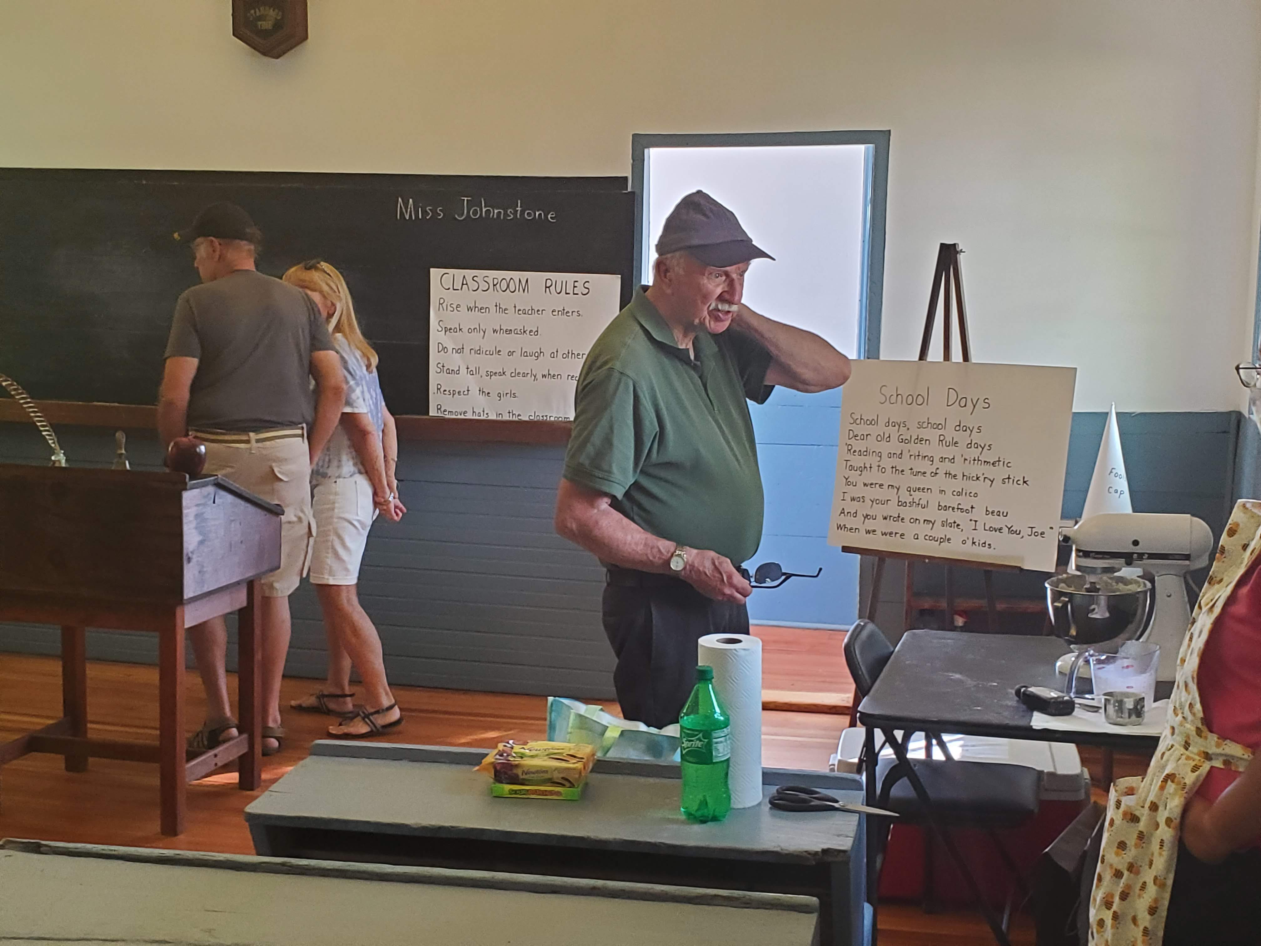 Visitors and a display inside the schoolhouse