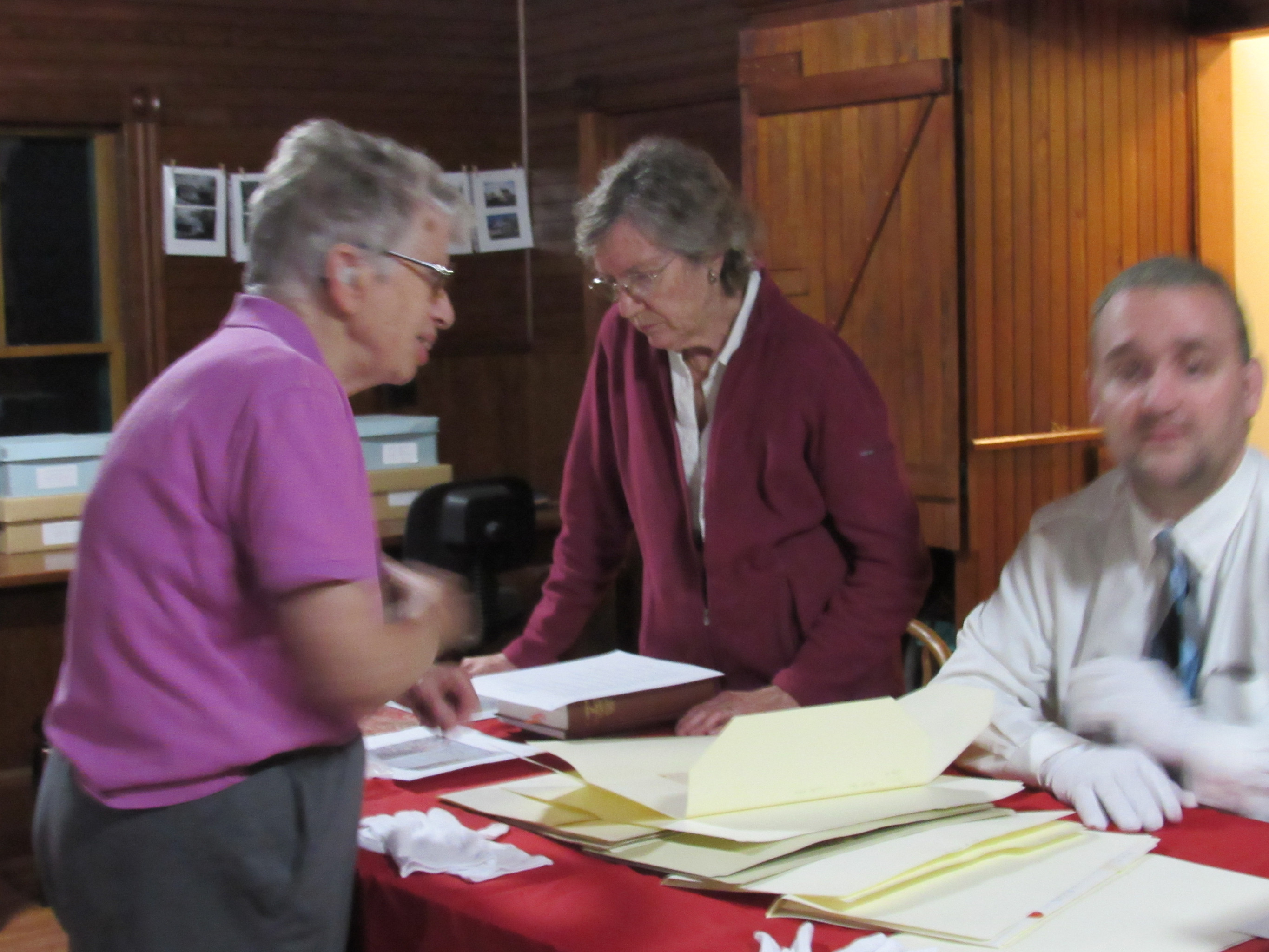 Visitors examining historical society archives