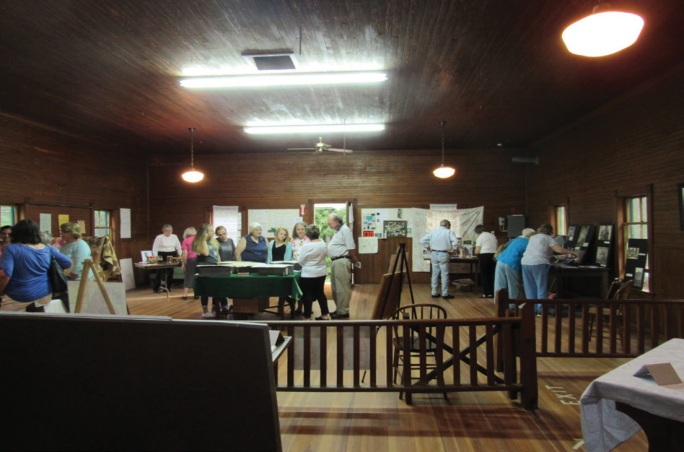 Visitors to the What’s In Those Boxes program in June explore a selection of items from our Archives.