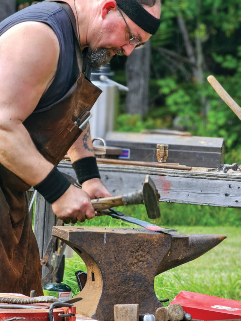 Ryan Adams of Bell Hill Forge, works a piece of hot steel at his live demonstration in August