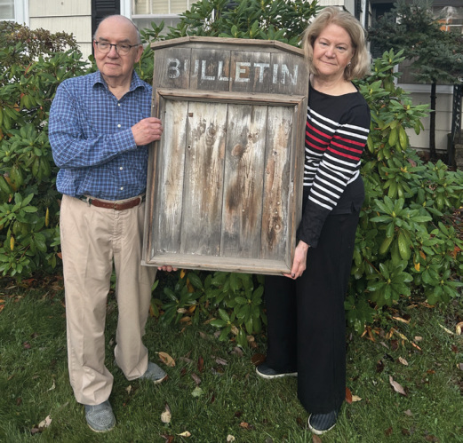 Clark and Jane Irwin pictured with the original bulletin board from the Spurr’s Corner Grange, which was demolished in 1967